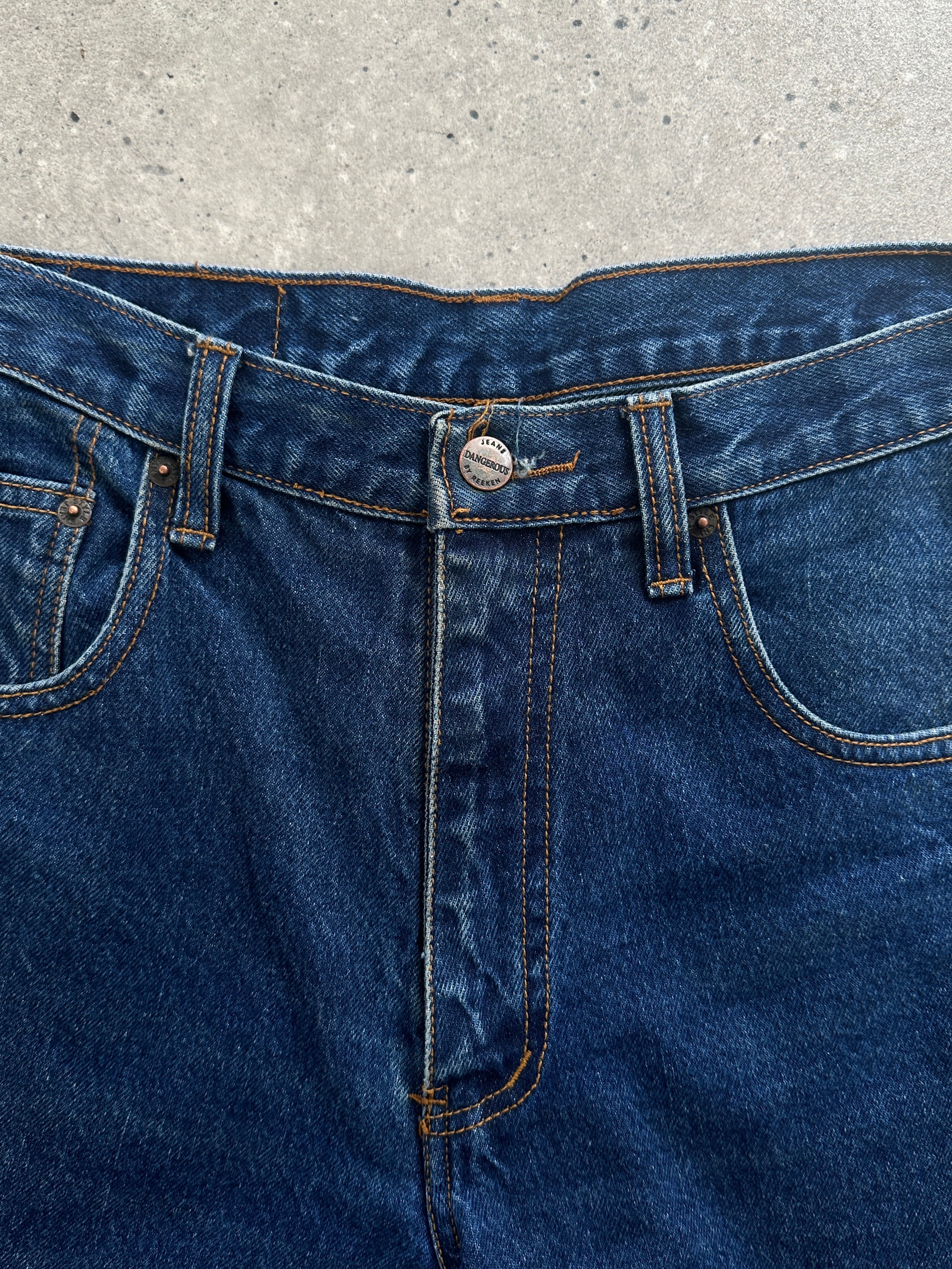 Vintage pure cotton straight leg denim jeans in size W28, shown hanging with classic blue denim fabric and sturdy construction.