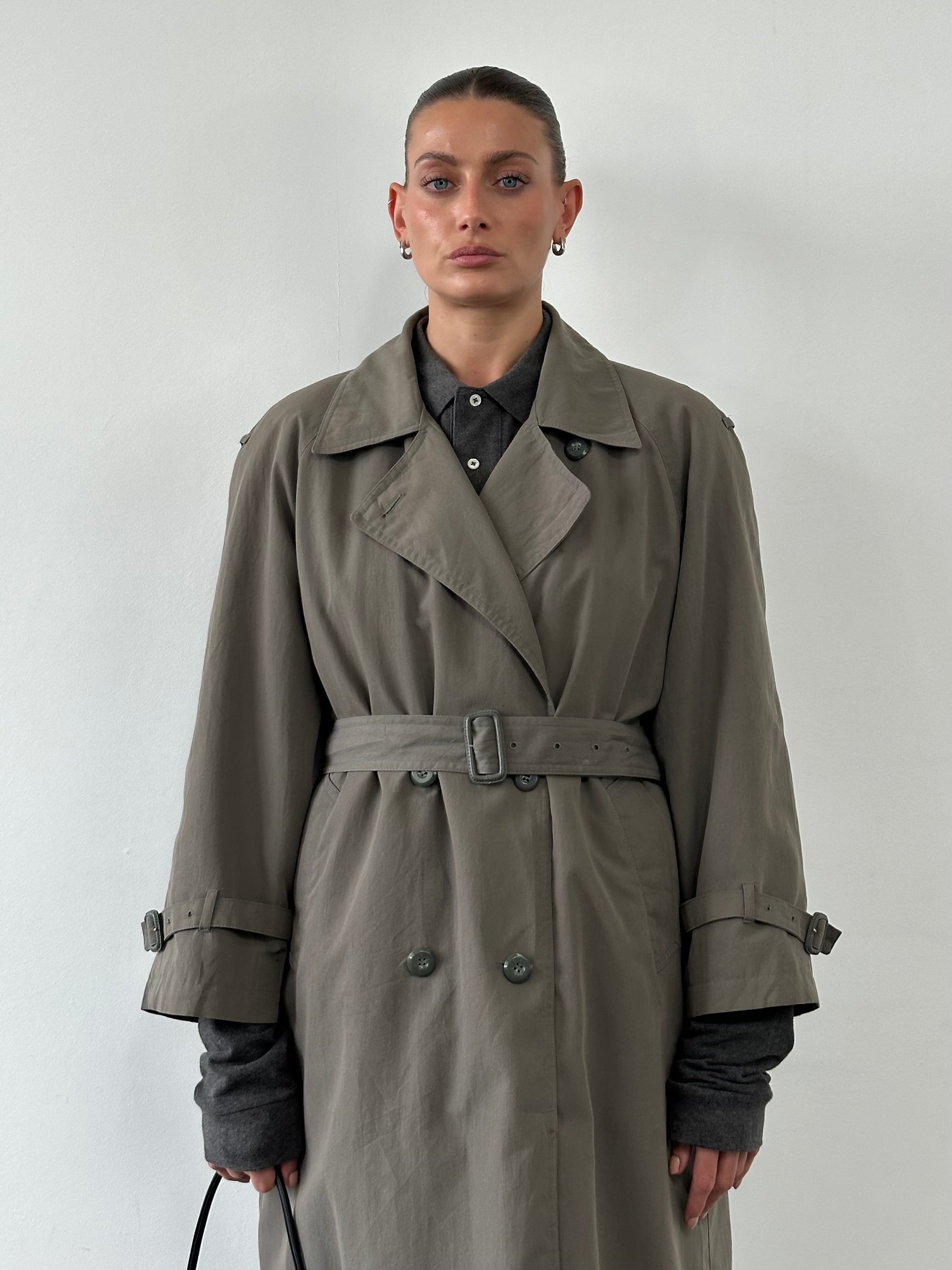 London Fog double-breasted trench coat in black, displayed on a hanger, showcasing classic style and tailored fit.