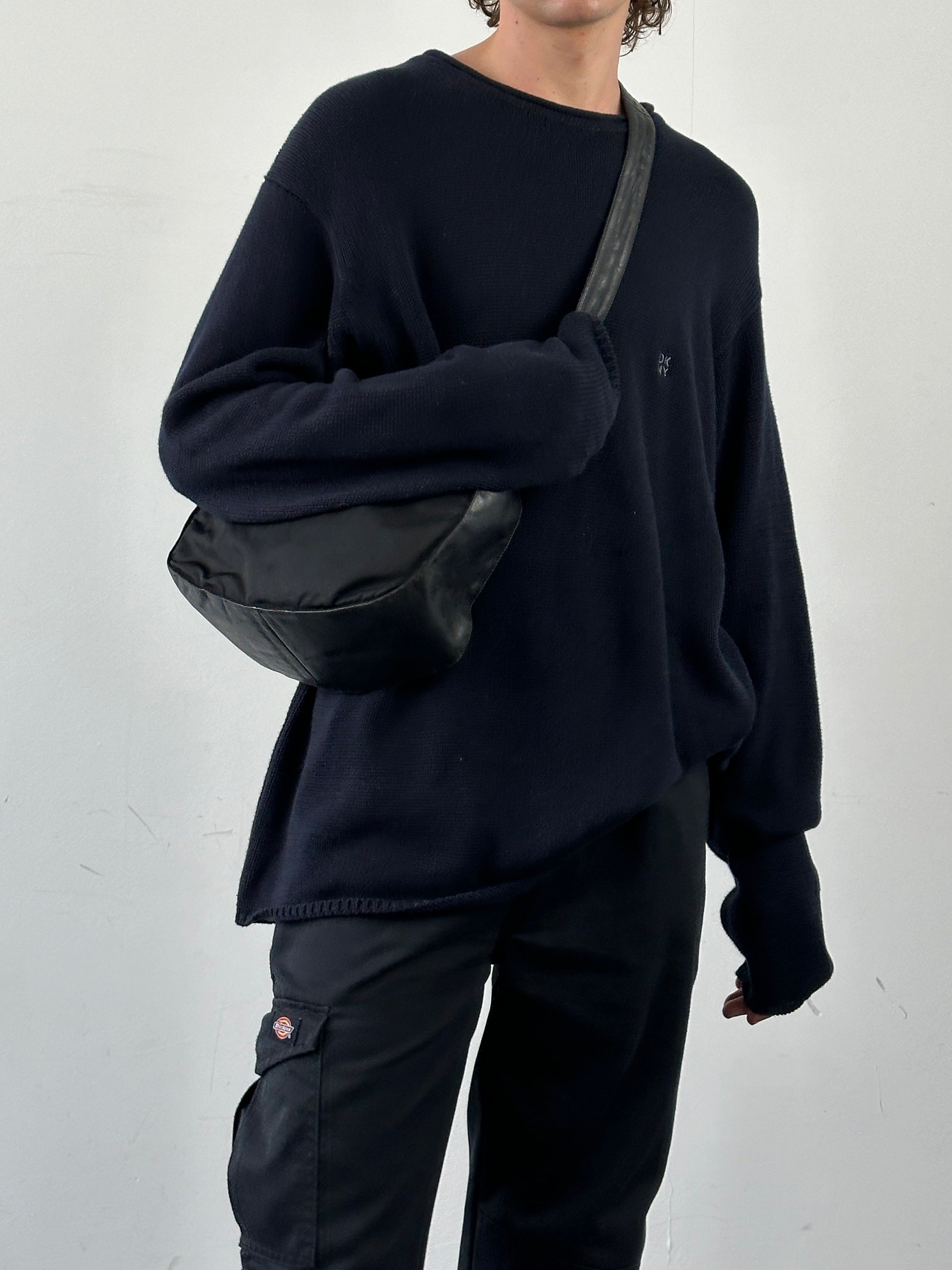 Prada nylon and leather crossbody bag with adjustable strap and sleek design, perfect for everyday use.