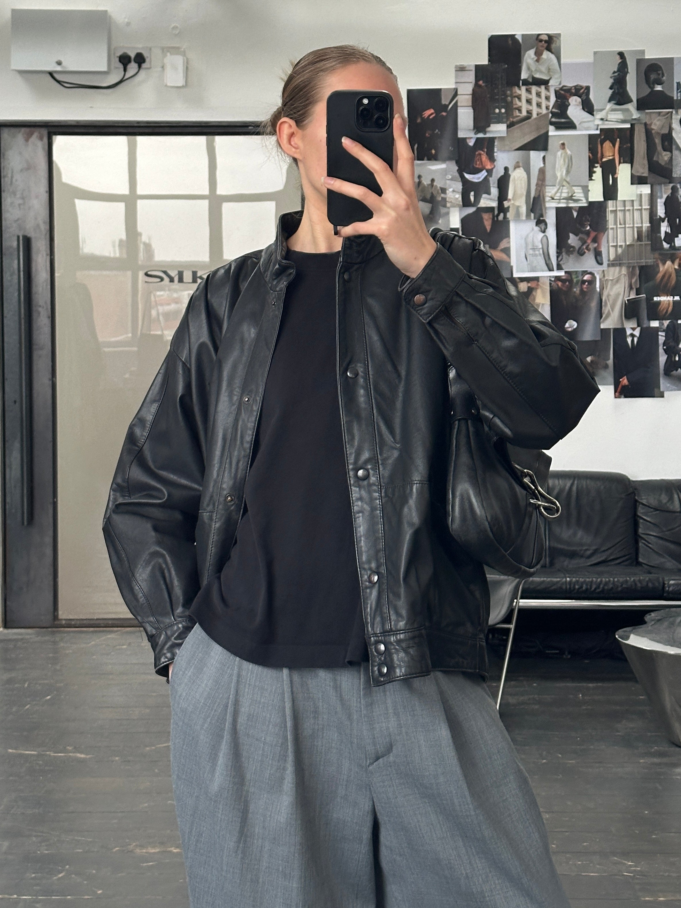 Vintage 1990s leather jacket in size M, classic brown leather with a structured collar and zip closure.