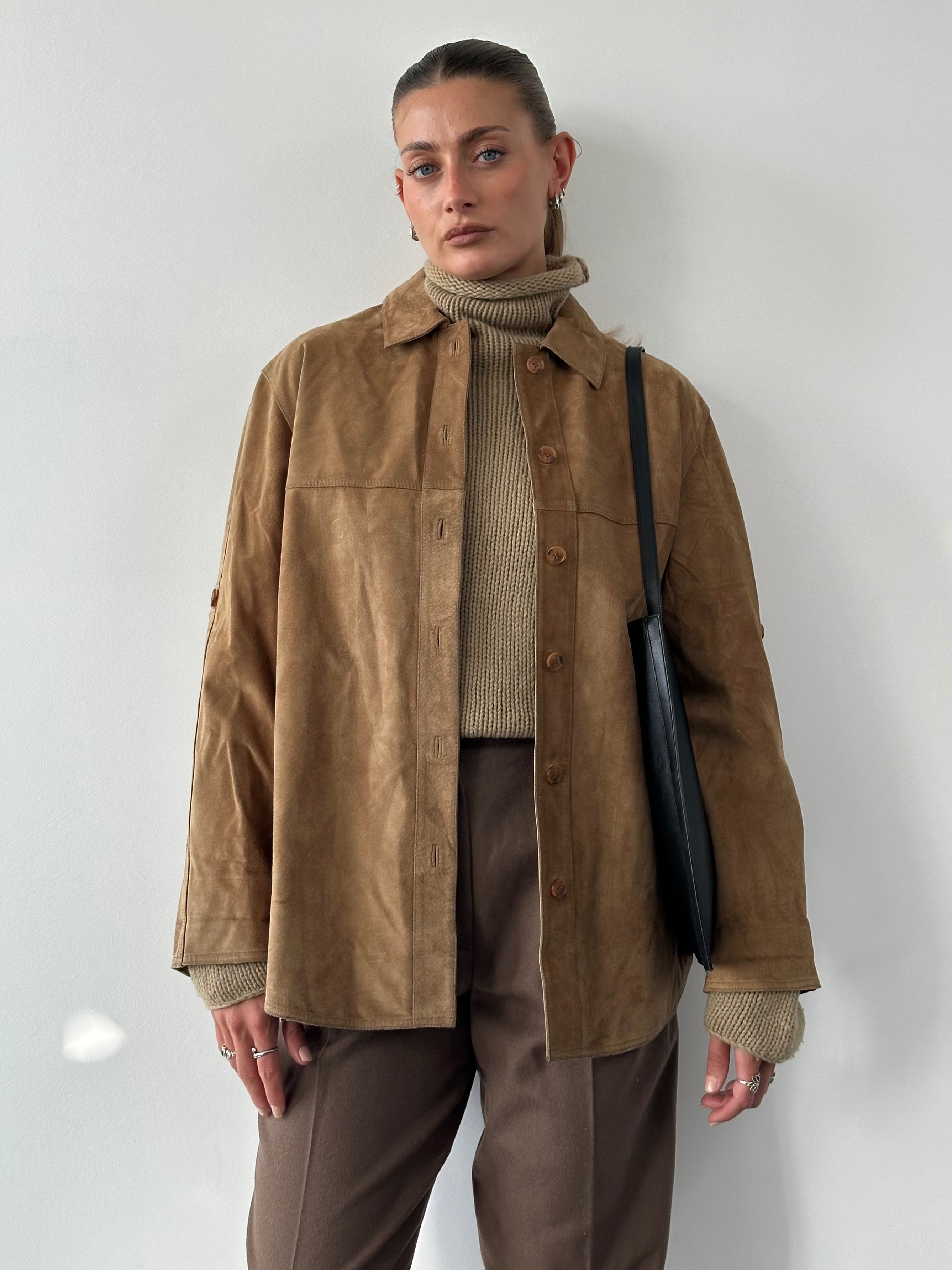 Vintage suede shirt in size L, featuring a classic design with a soft texture and stylish collar, displayed on a hanger.