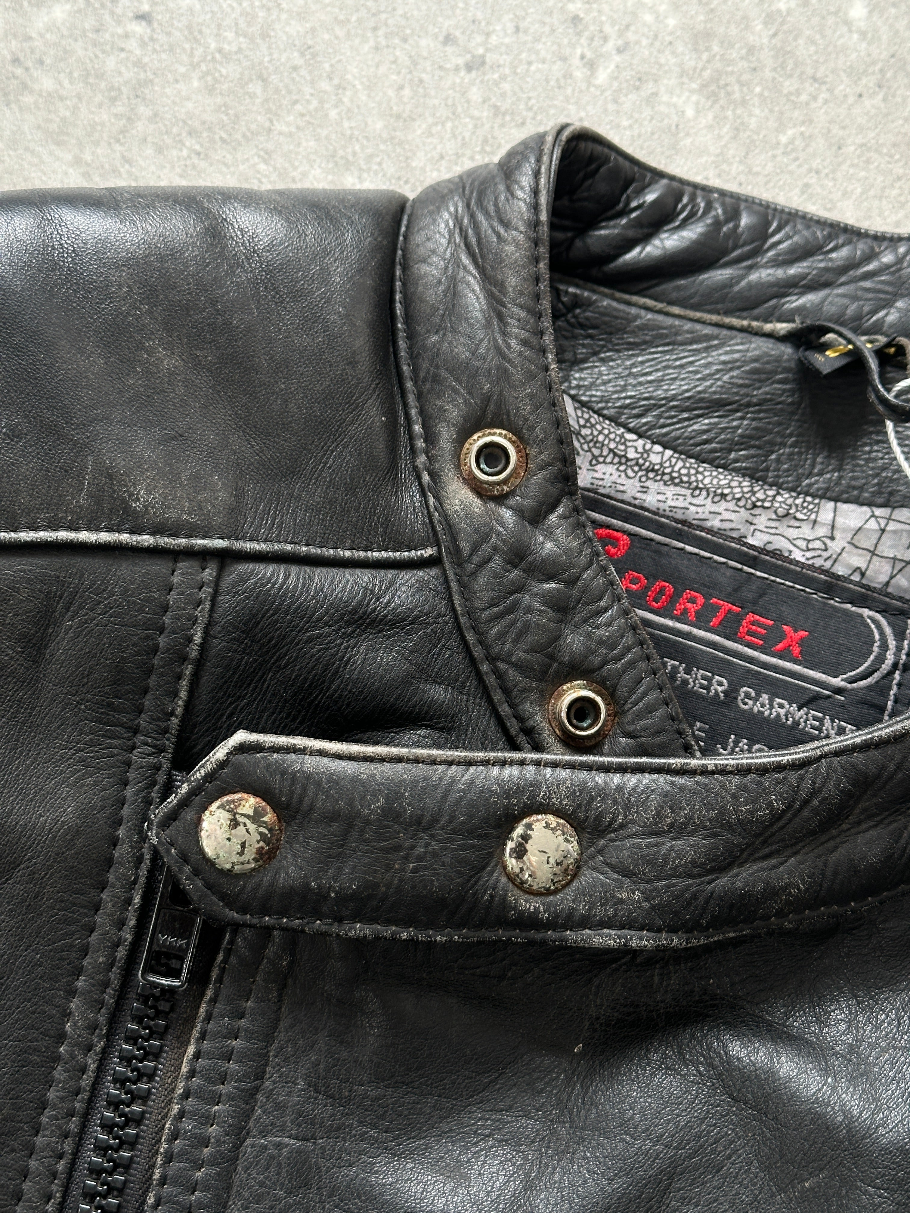 Vintage distressed motorcycle leather jacket in size L/XL, featuring rugged design and classic biker style.