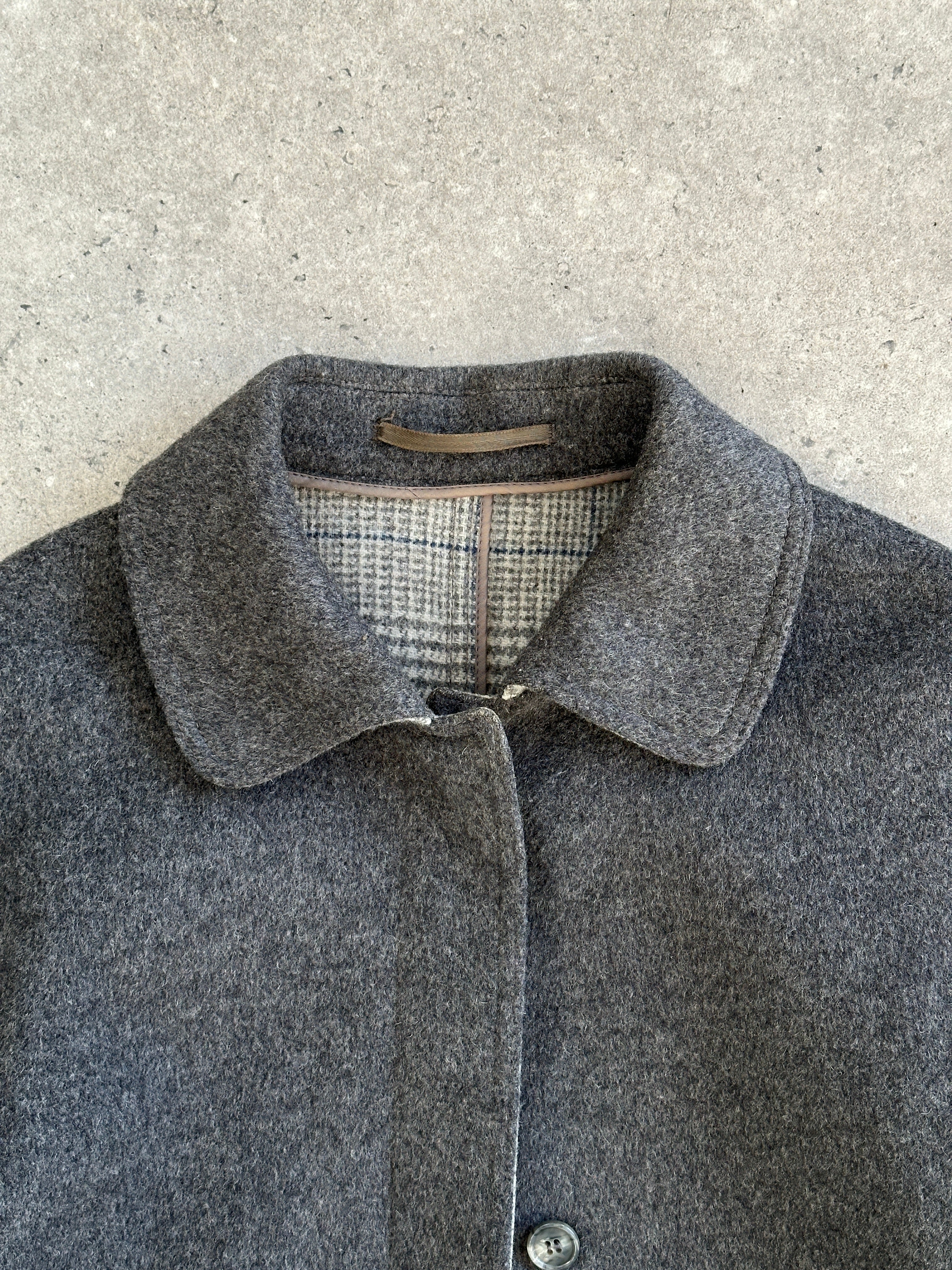 Vintage 1980s wool belted coat with concealed placket, featuring classic design and tailored fit in a warm, textured fabric.