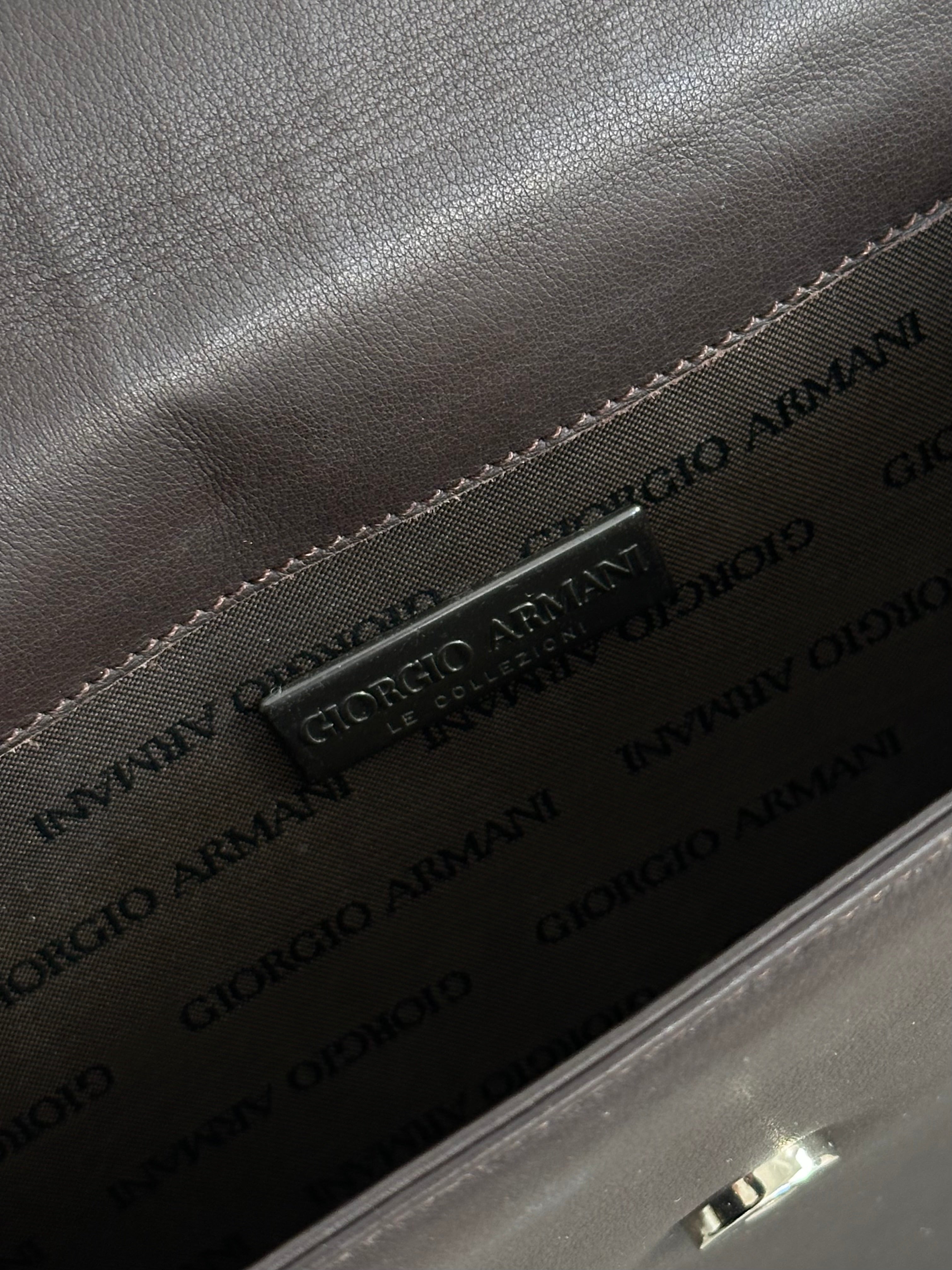 Giorgio Armani Le Collezioni leather shoulder bag in black with sleek design and adjustable strap.