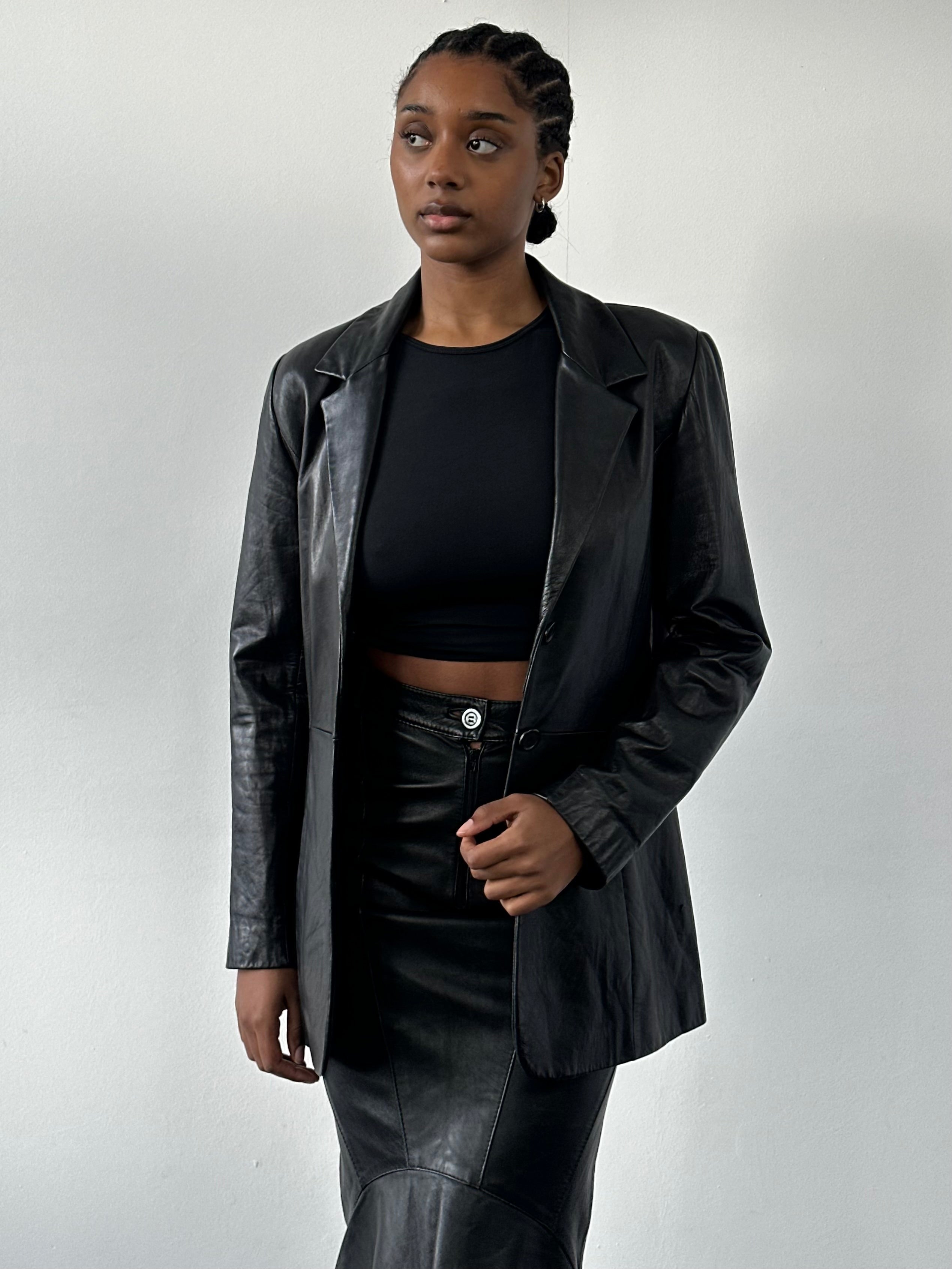 Vintage 1990s fitted leather jacket, small size, showcasing classic black leather with a tailored design and stylish collar.