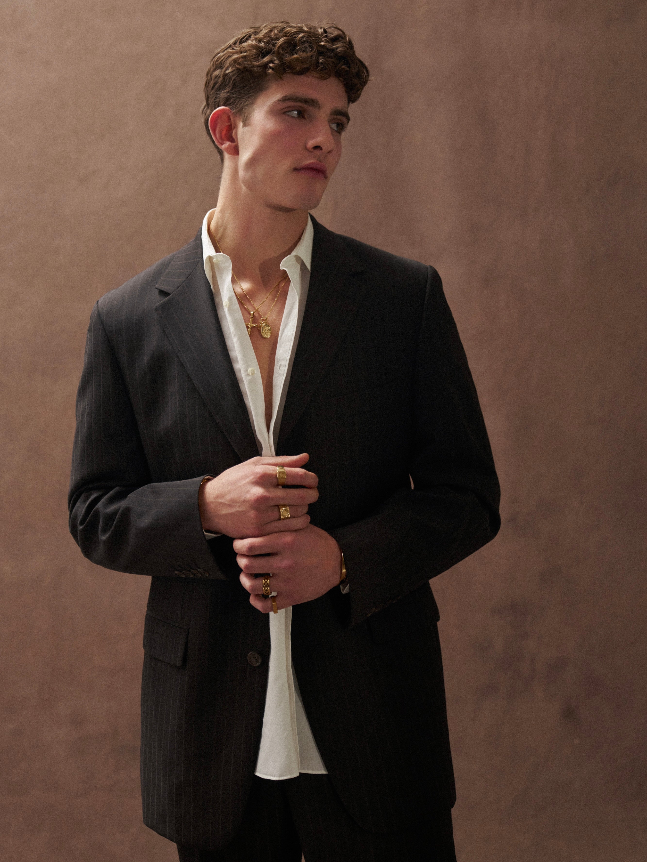 Yves Saint Laurent Pour Homme pinstripe pure wool single-breasted suit in size 40R/W32, displayed as a stylish jumpsuit.