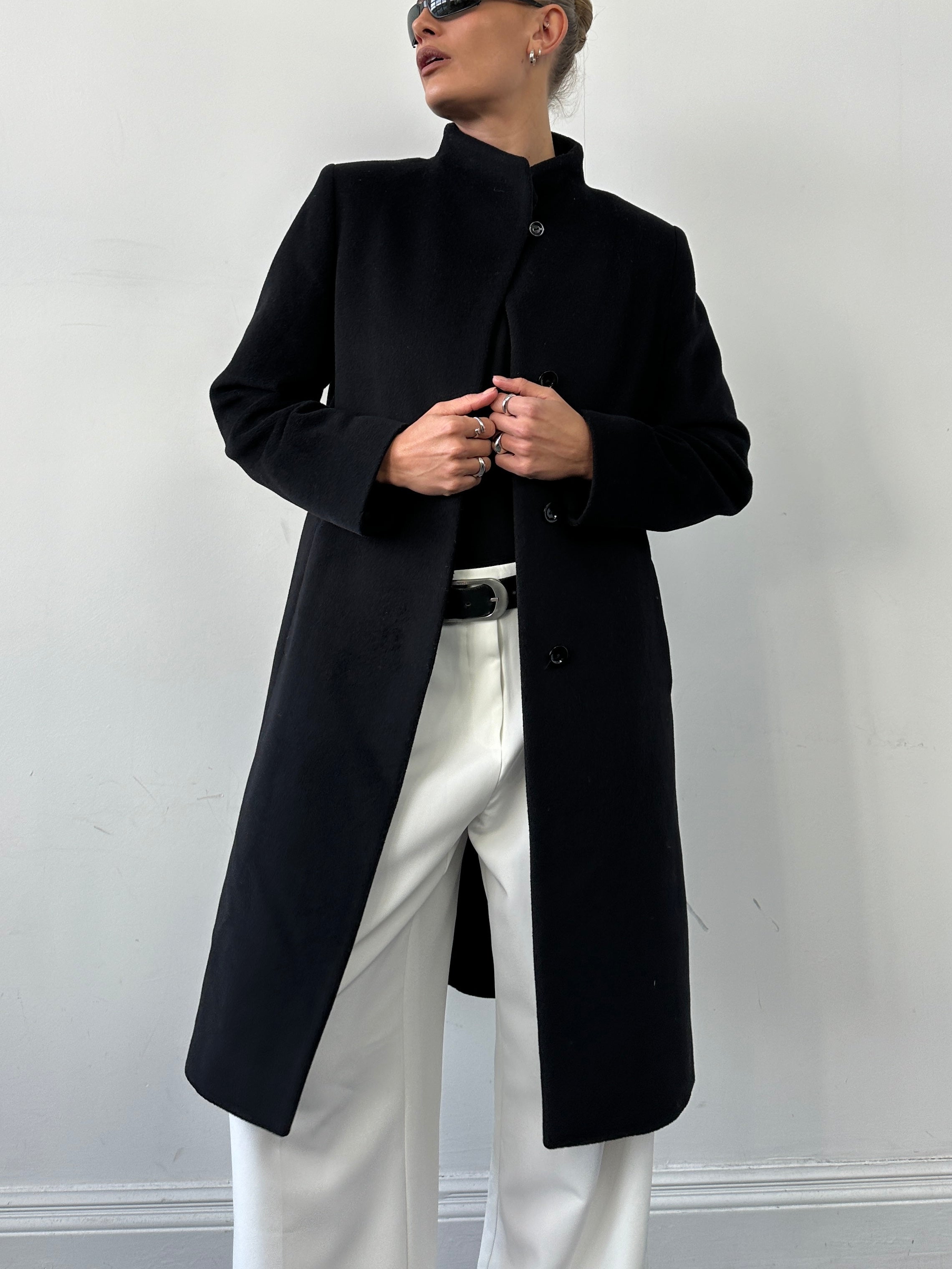 Cinzia Rocca minimal high neck pure wool coat in neutral color, displayed on a hanger. Elegant winter outerwear for women.