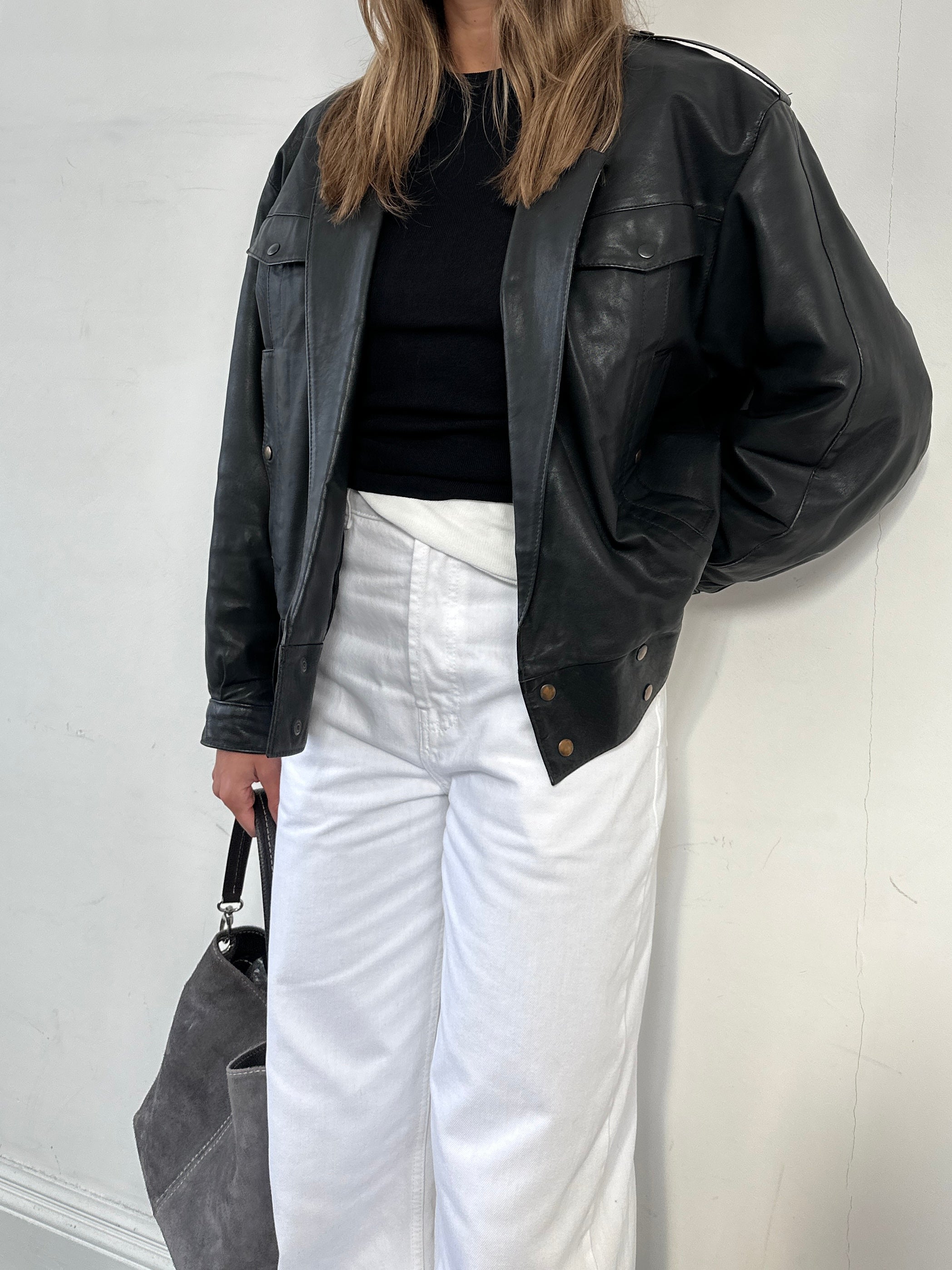Vintage leather bomber jacket in size small, featuring a classic design with a front zipper and ribbed cuffs.