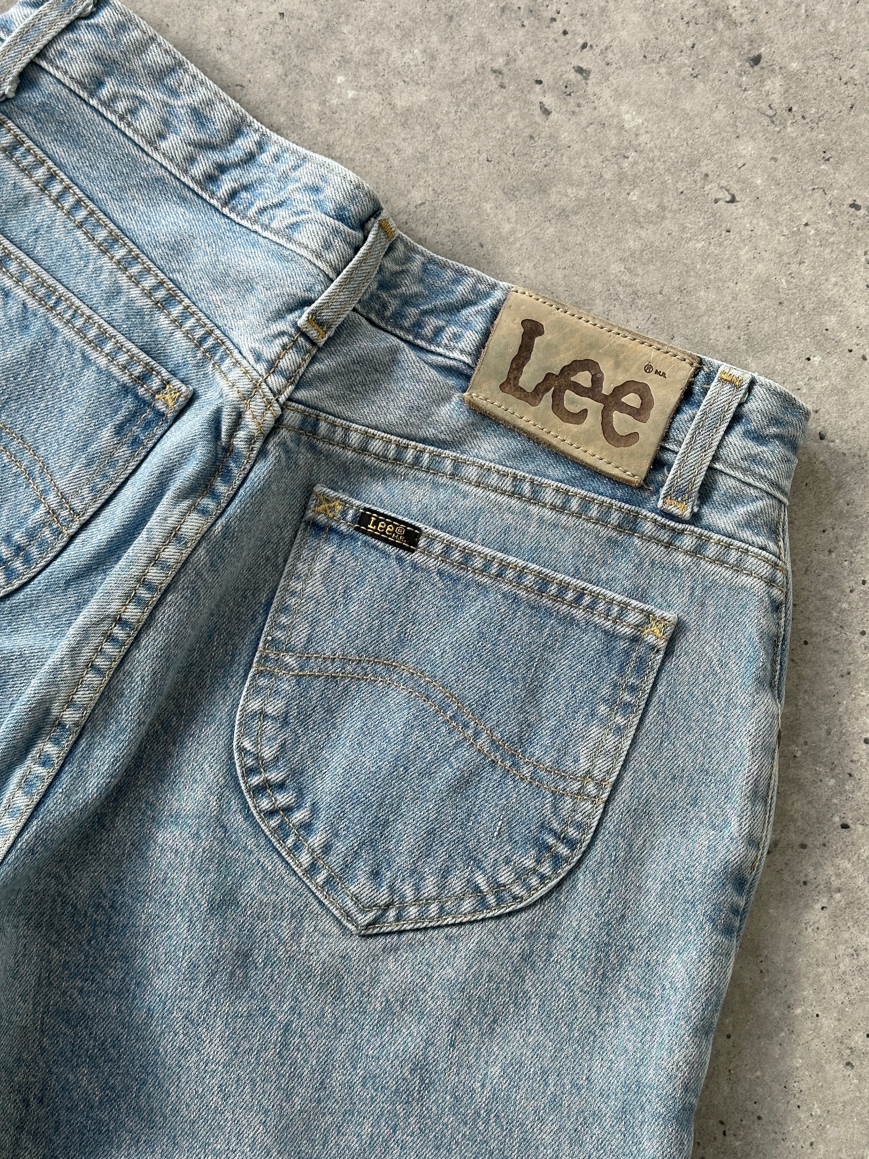 Lee high waisted light wash denim jeans with a relaxed fit and classic five-pocket design, shown on a mannequin.