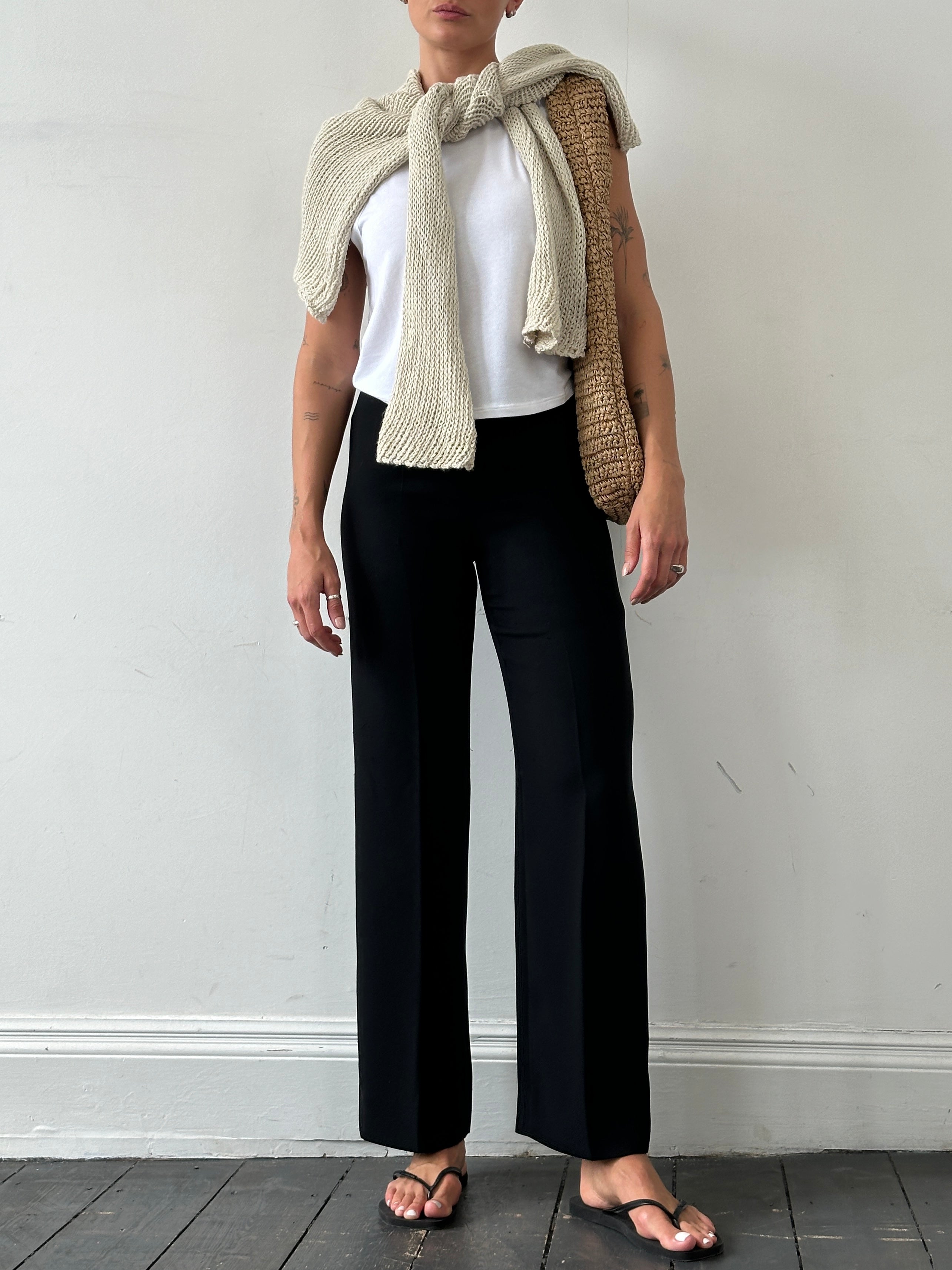 Marella minimal straight-leg mid-waist trousers in neutral fabric, displayed on a hanger against a plain background.
