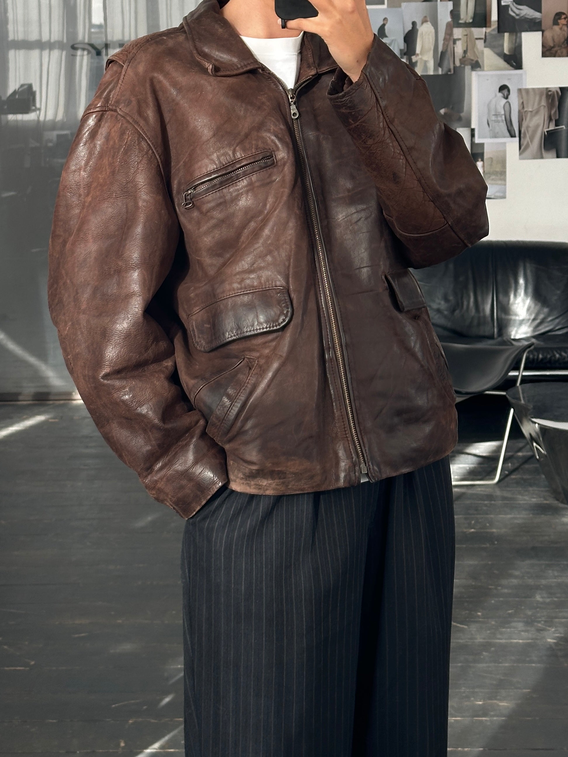 Vintage French 1980s boxy leather jacket, aged brown leather, vintage brand, with classic collar and distressed finish.