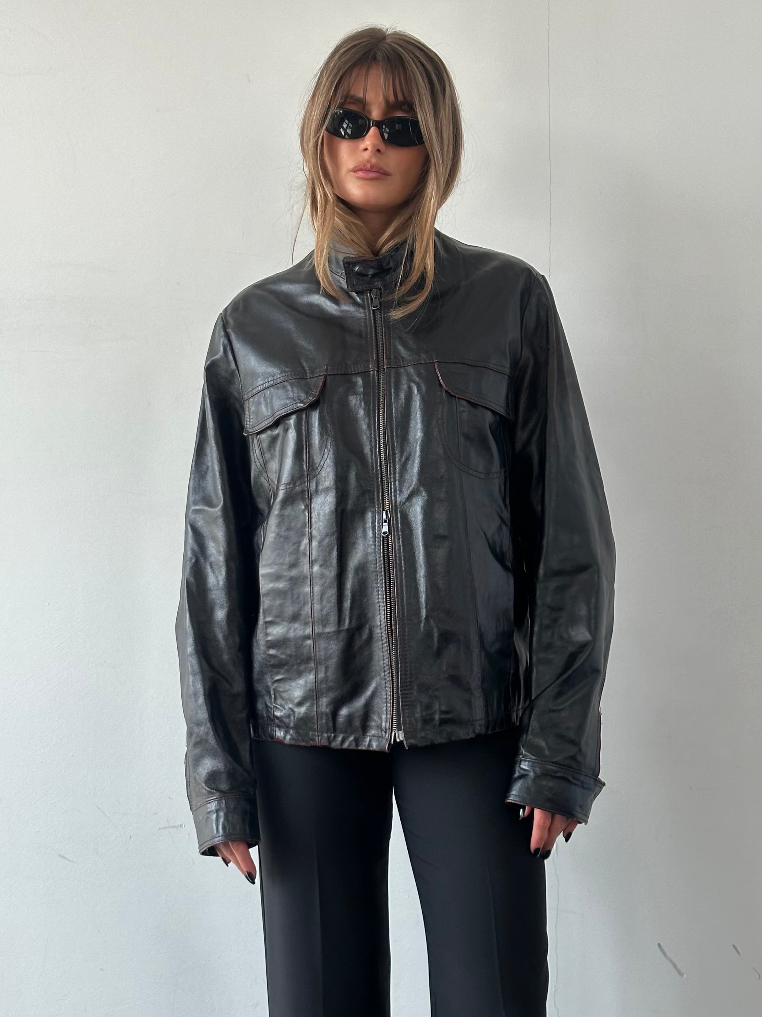 Vintage Italian distressed leather double zip jacket in size L/XL, featuring a rugged vintage style and textured leather finish.