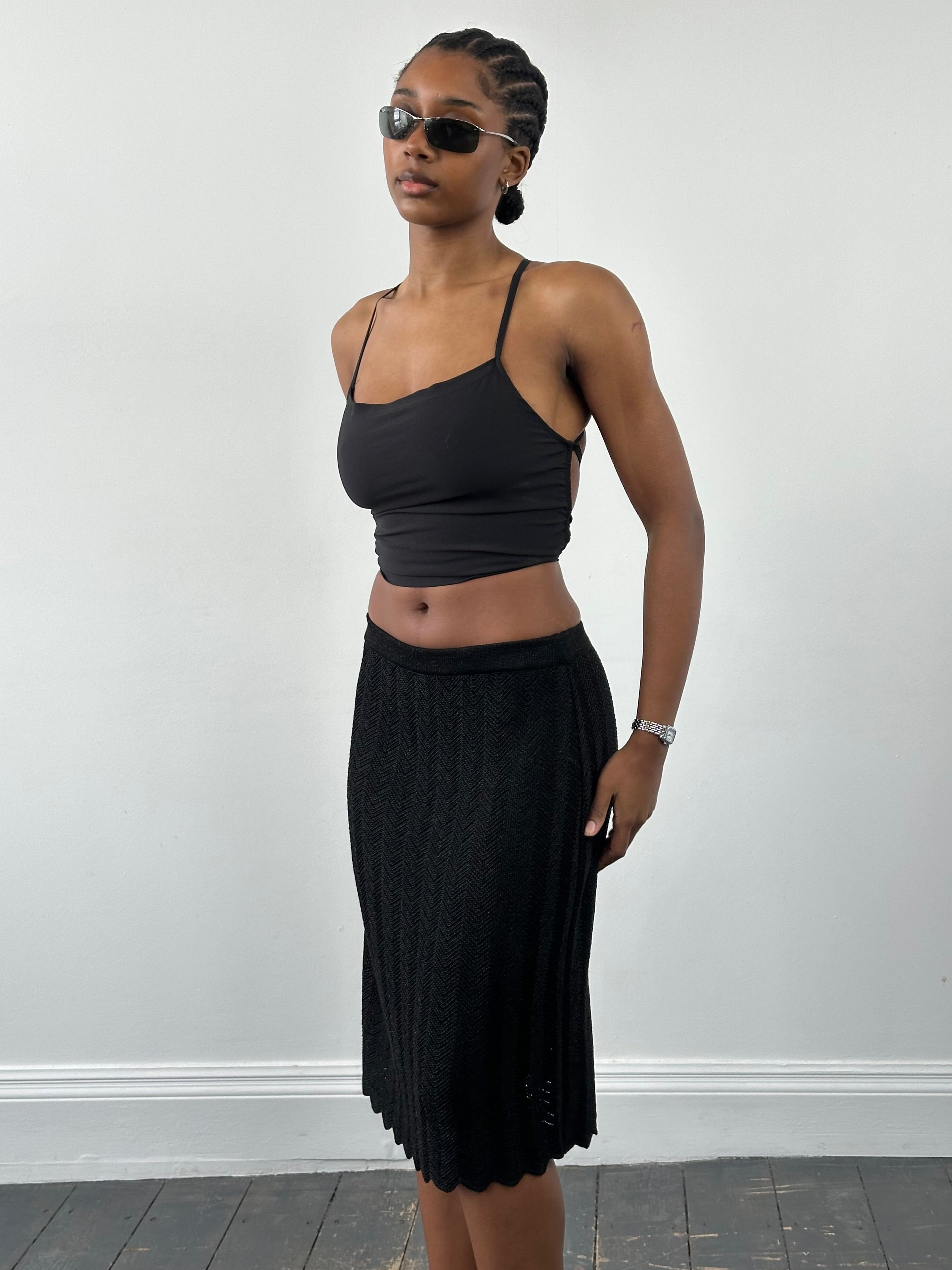 Vintage 1990s knit mini skirt in neutral tones, showcasing a fitted waist and textured fabric, size W26-30.