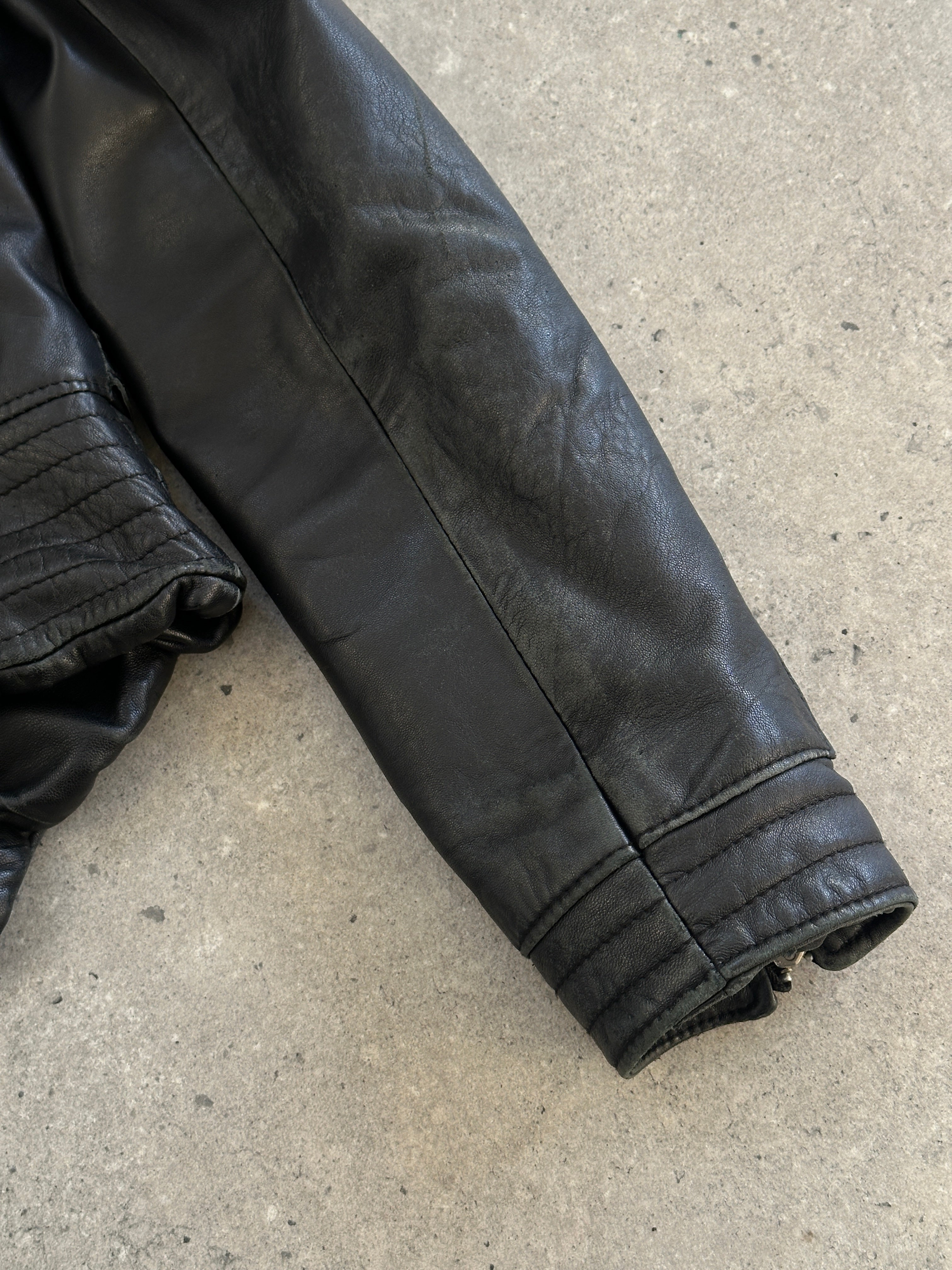 Vintage Italian 1990s fitted leather jacket with buckled detailing, size small, classic vintage leather jacket style.