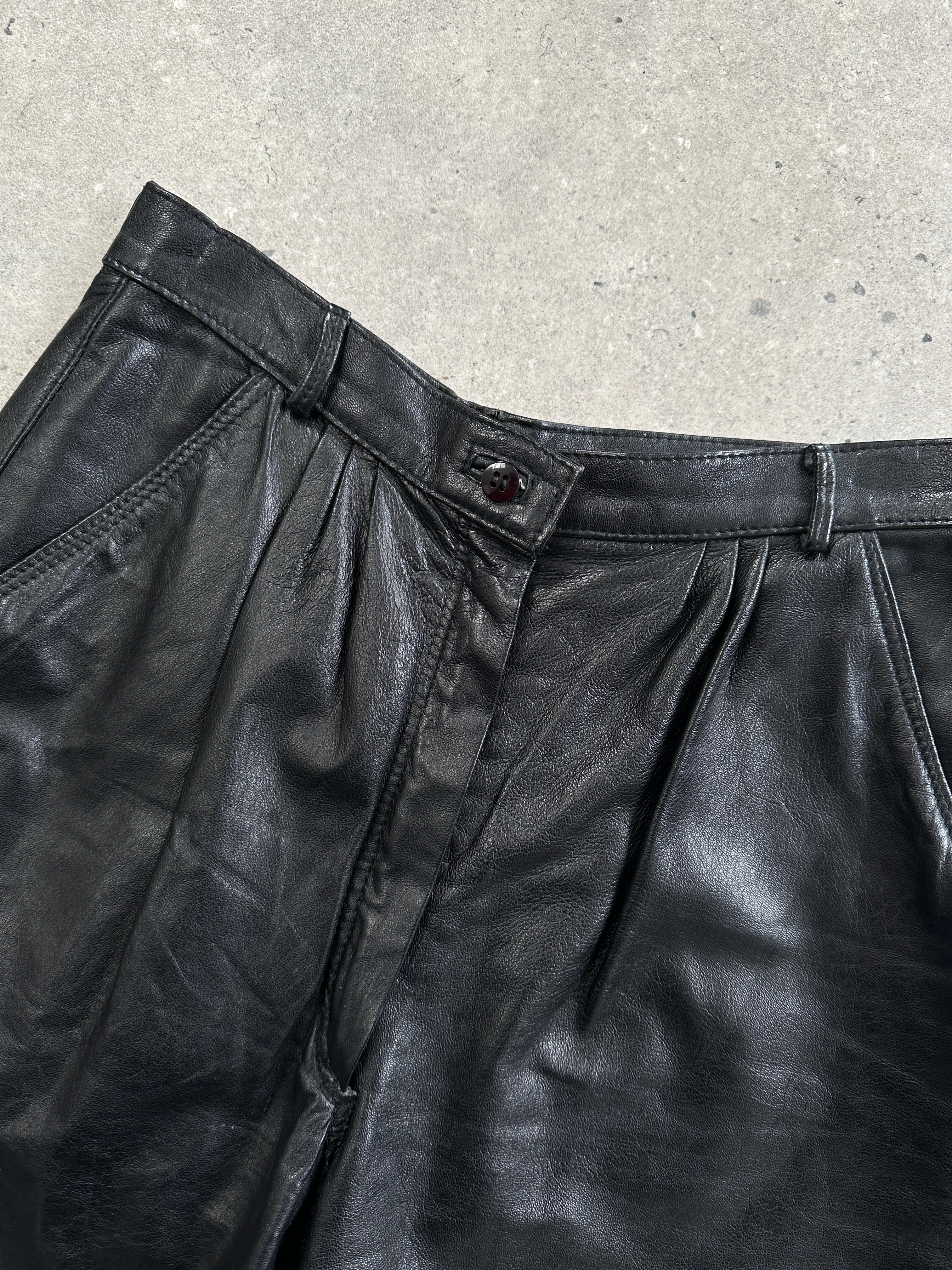 Vintage Italian high-waisted tapered leg leather trousers in W26, showcasing a classic vintage style with a fitted silhouette.