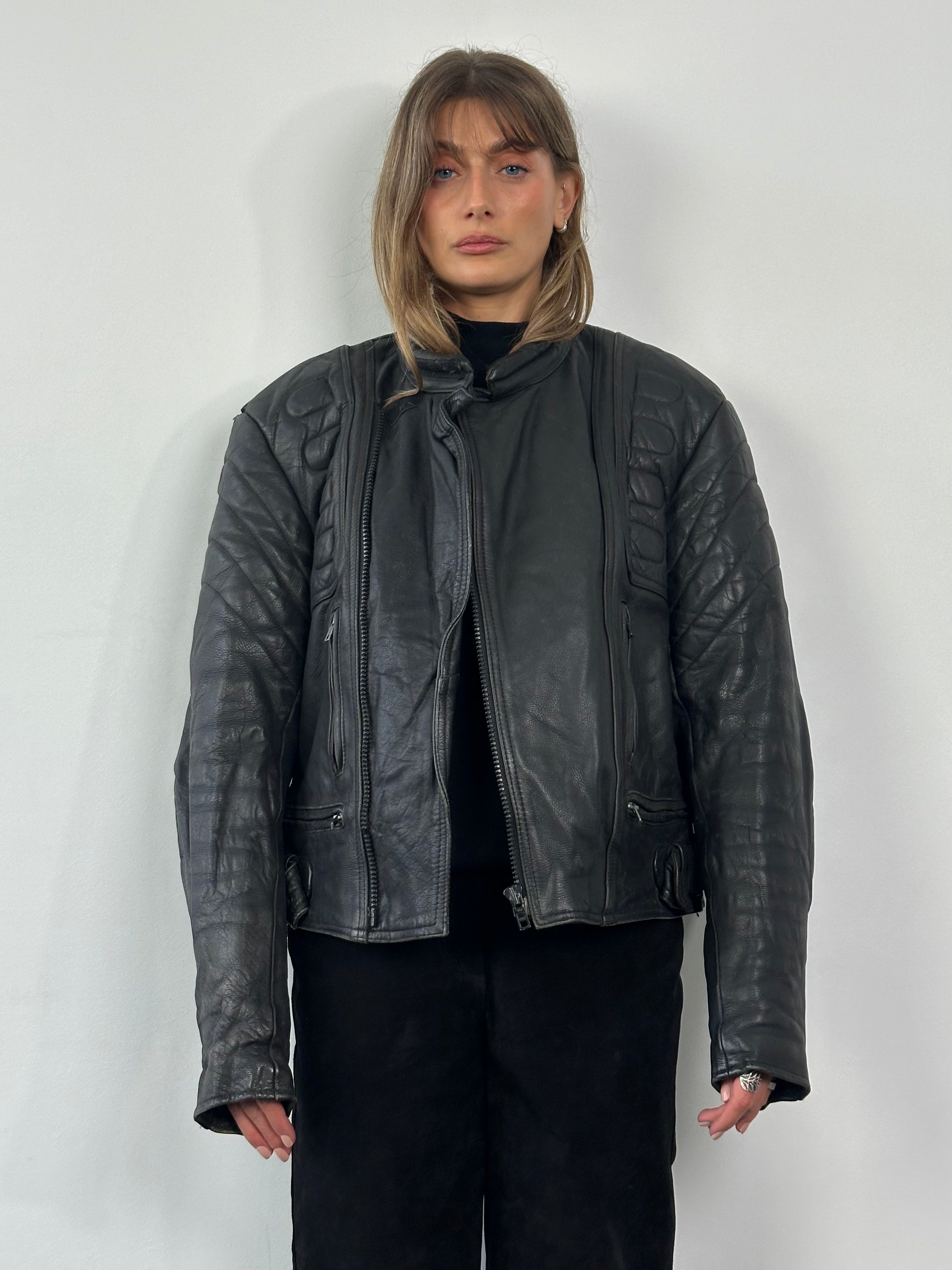 Vintage structured motorcycle leather jacket in size L/XL, featuring classic design, sturdy build, and detailed stitching.