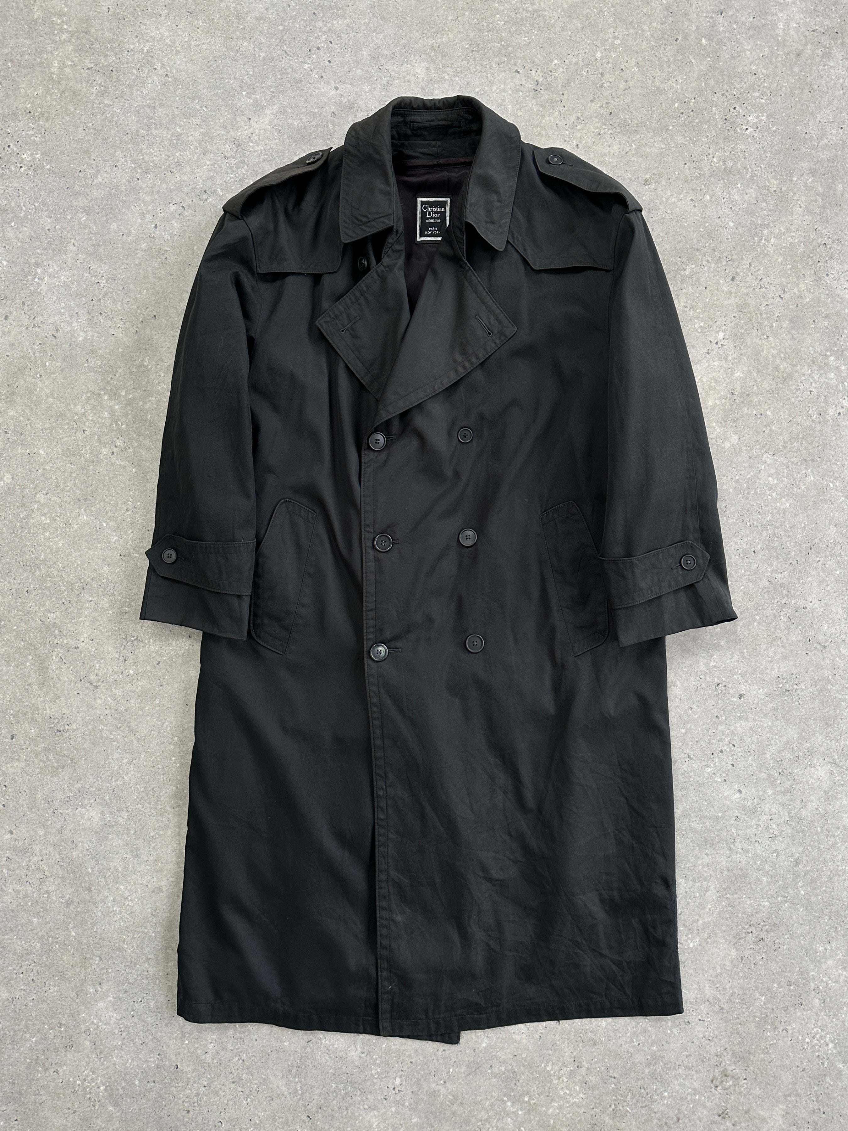 Christian Dior Monsieur double-breasted trench coat in XL, displayed on a hanger with classic beige fabric and stylish design details.