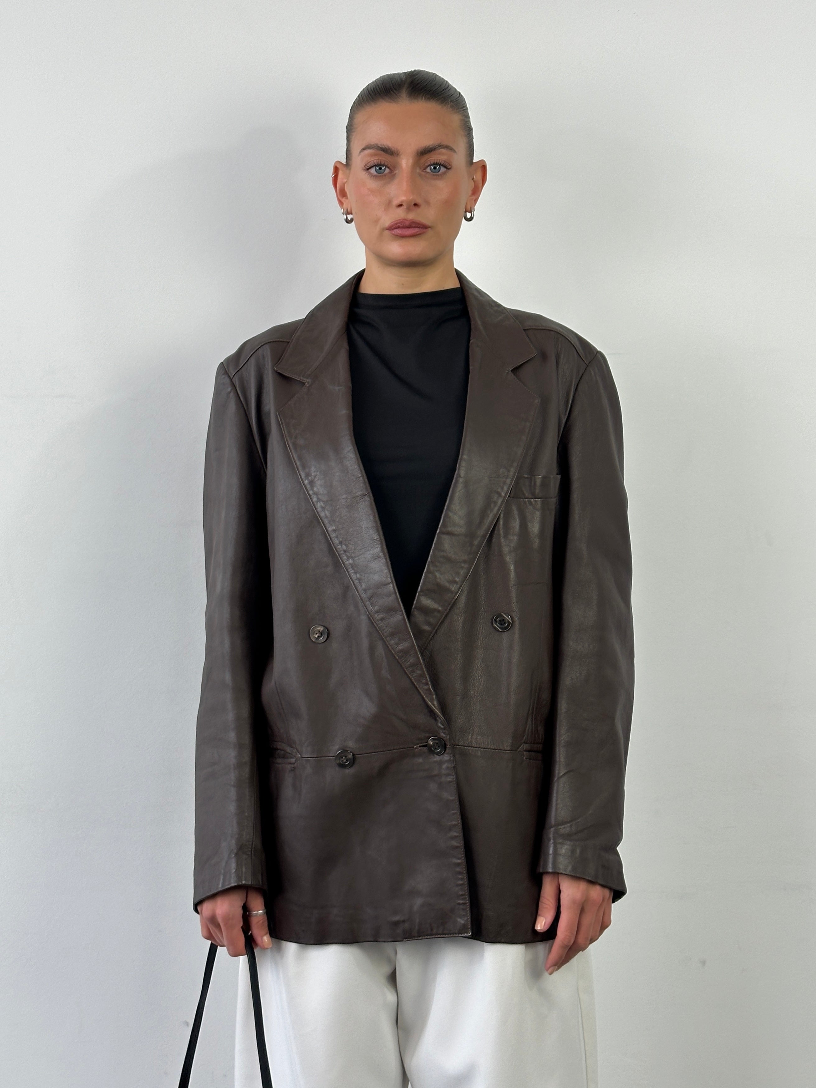 Vintage double-breasted leather blazer jacket in size L, featuring classic design and tailored fit, displayed on a hanger.