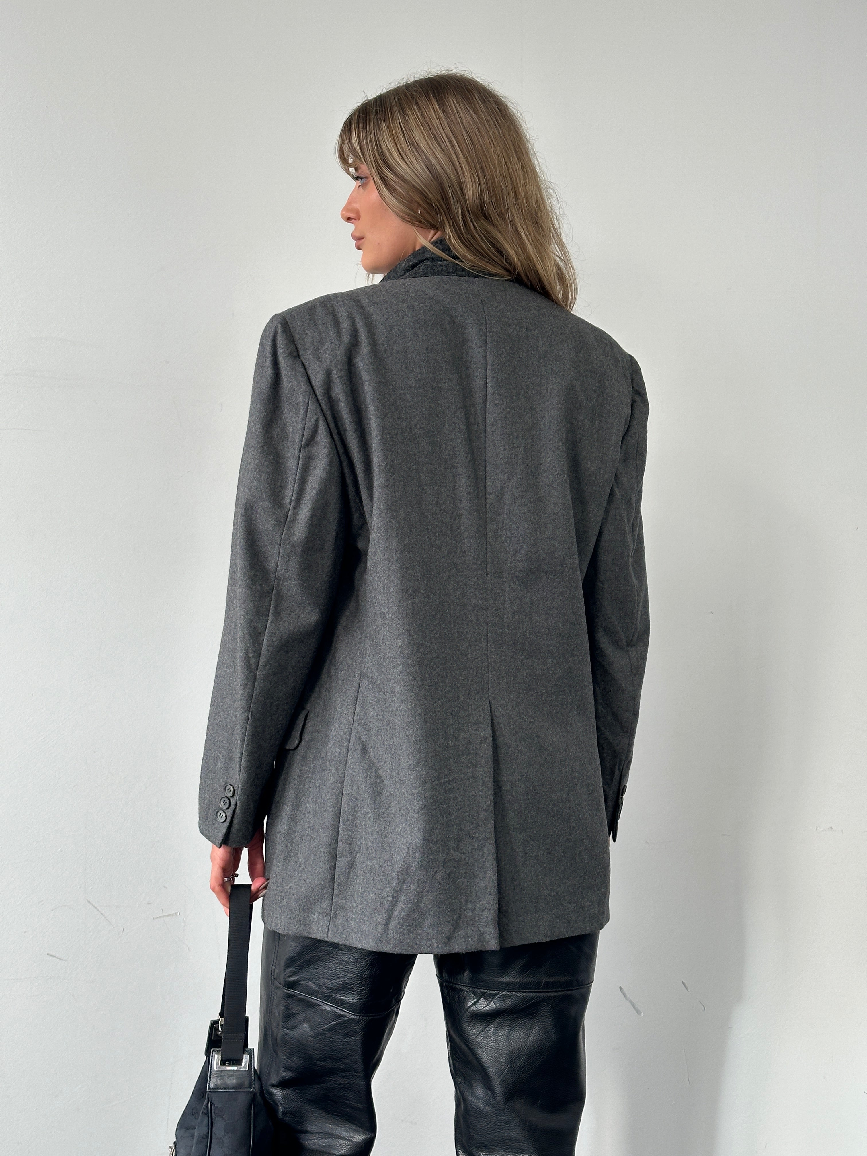 Christian Dior pure wool blazer in size L, tailored fit with notched lapels and button closure, shown on a hanger.