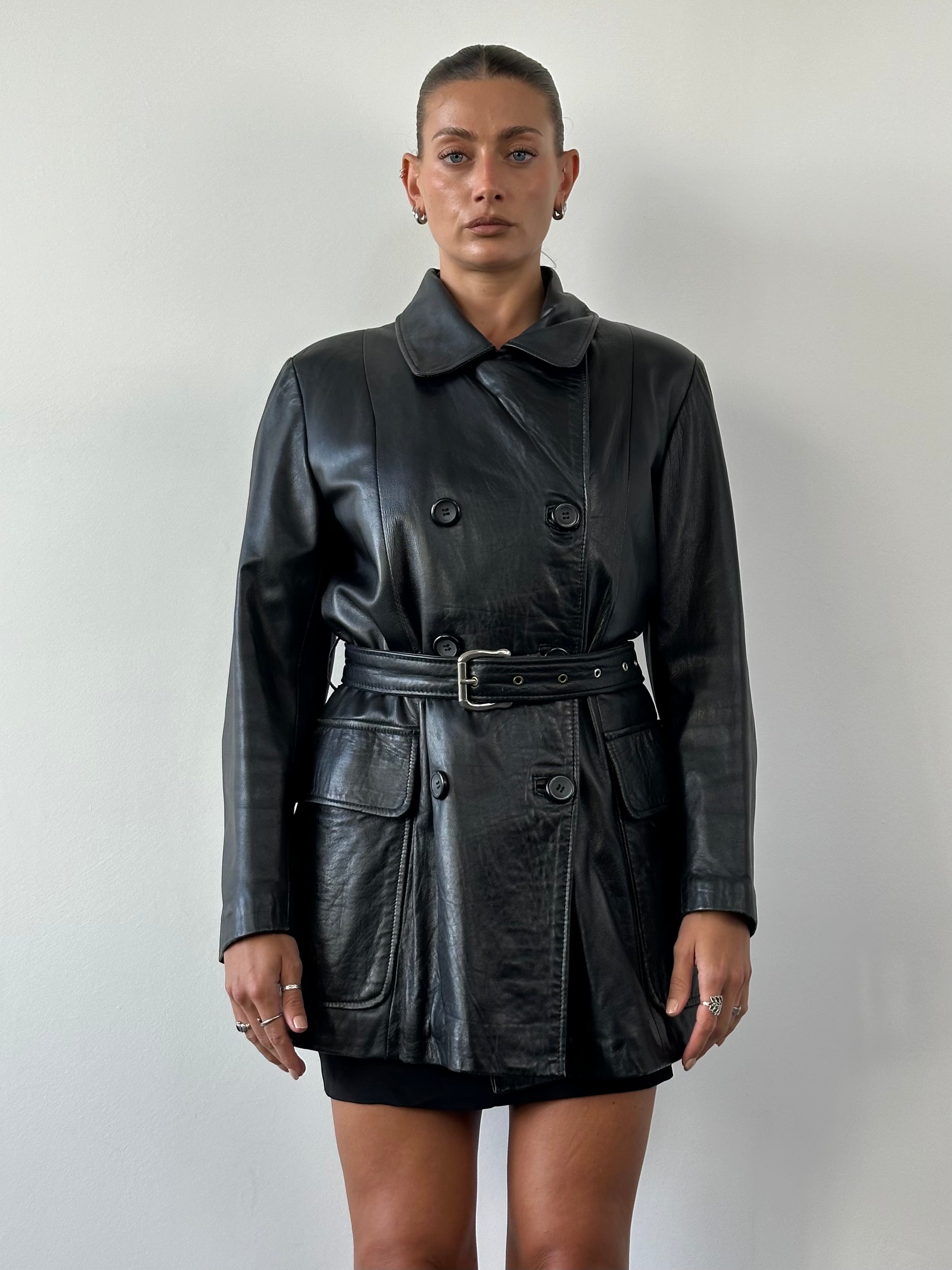 Vintage double-breasted belted leather jacket in smooth leather, size L/XL, featuring classic design and metal button details.