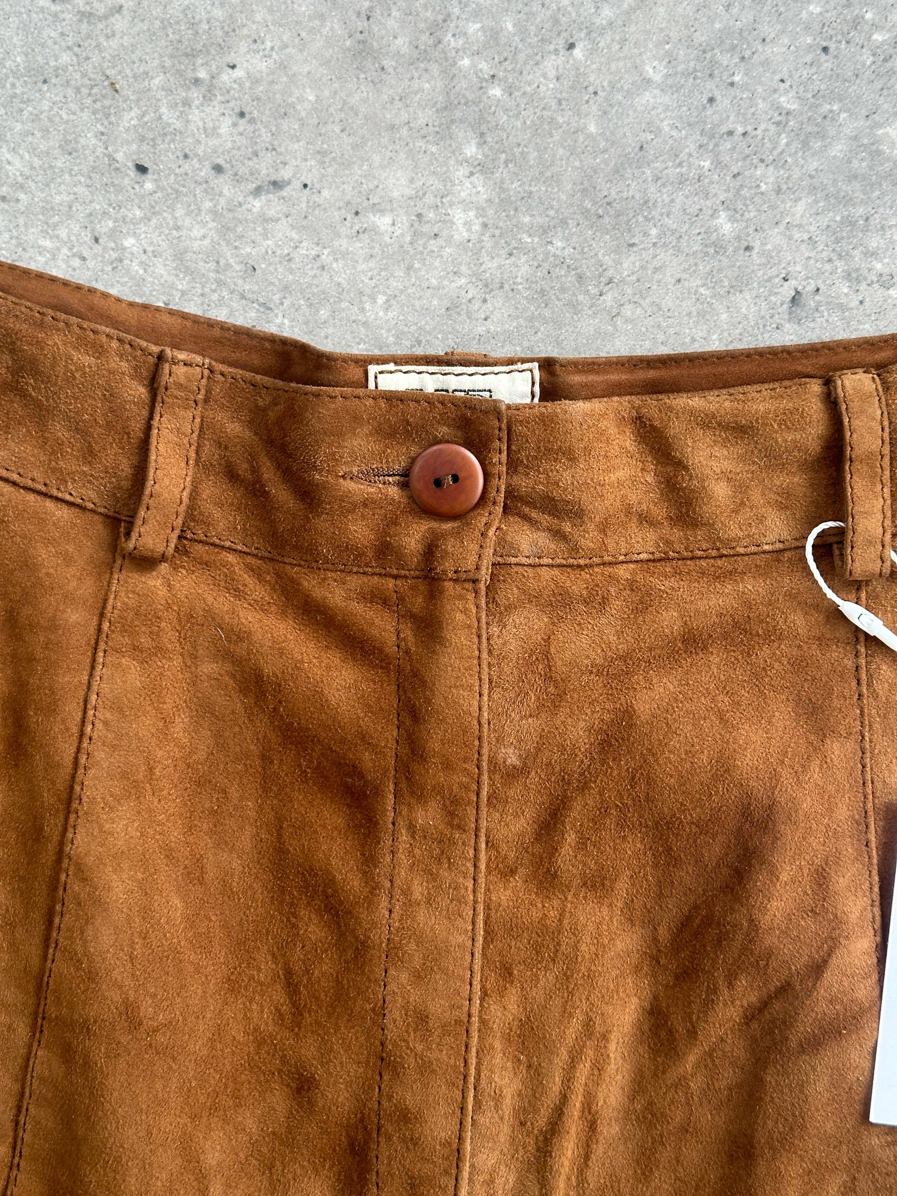 Italian vintage high waisted suede leather shorts in a warm brown color, displayed on a neutral background.