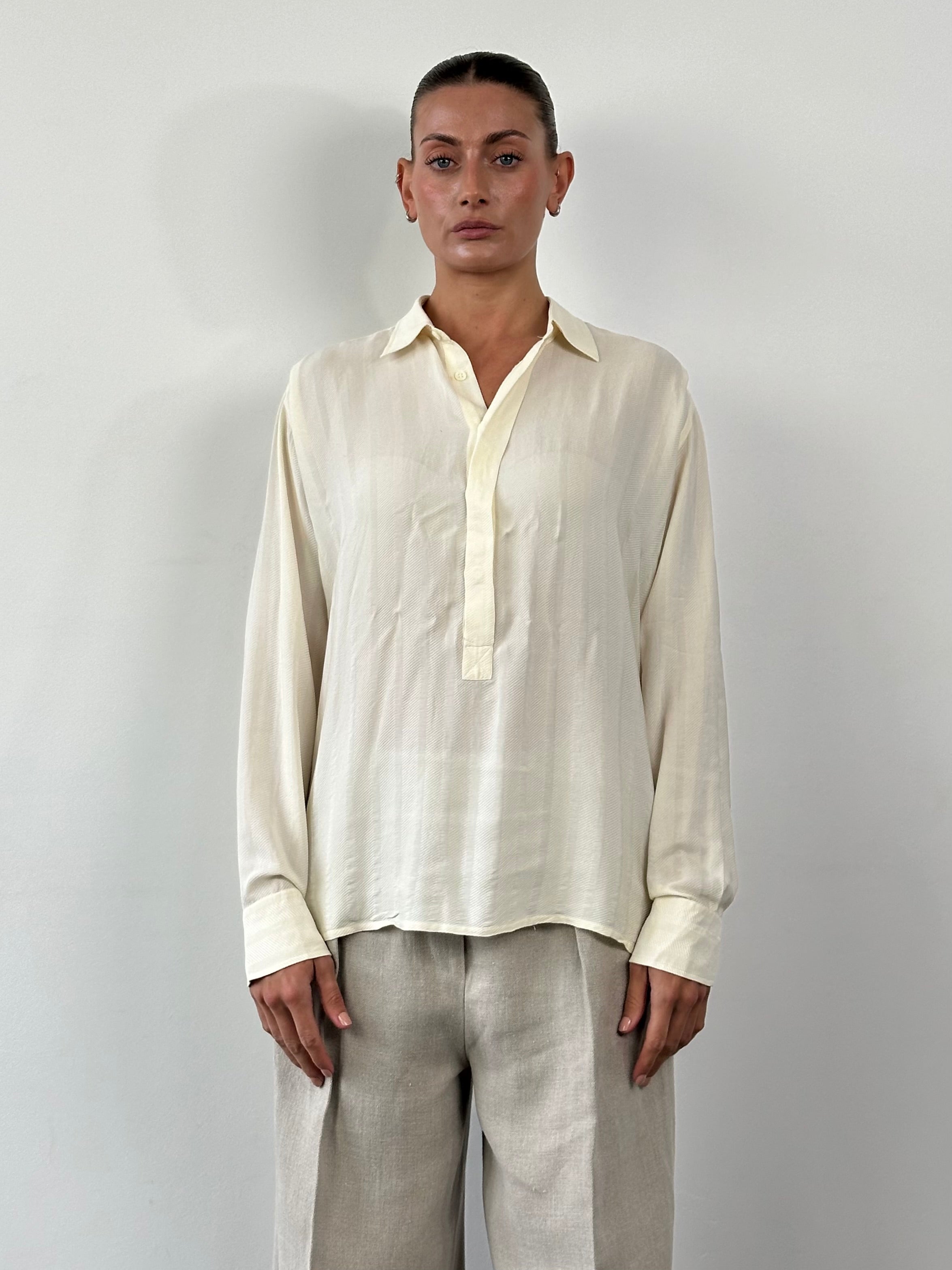 Vintage pure silk polo shirt in size L/XL, featuring a classic collar and smooth fabric, displayed on a neutral background.