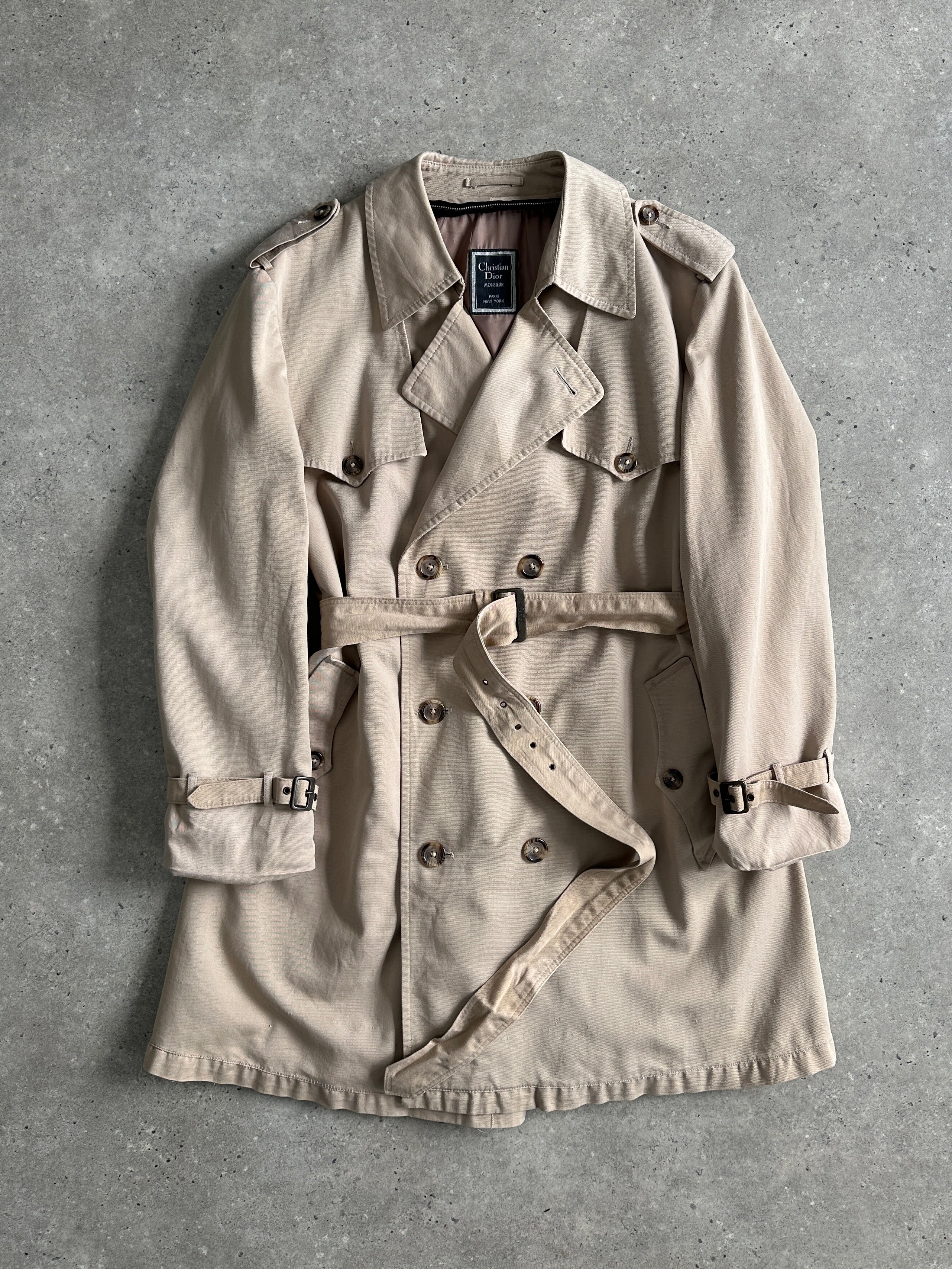 Christian Dior Monsieur cotton double-breasted belted trench coat in size L/XL, shown on a mannequin with classic design details.