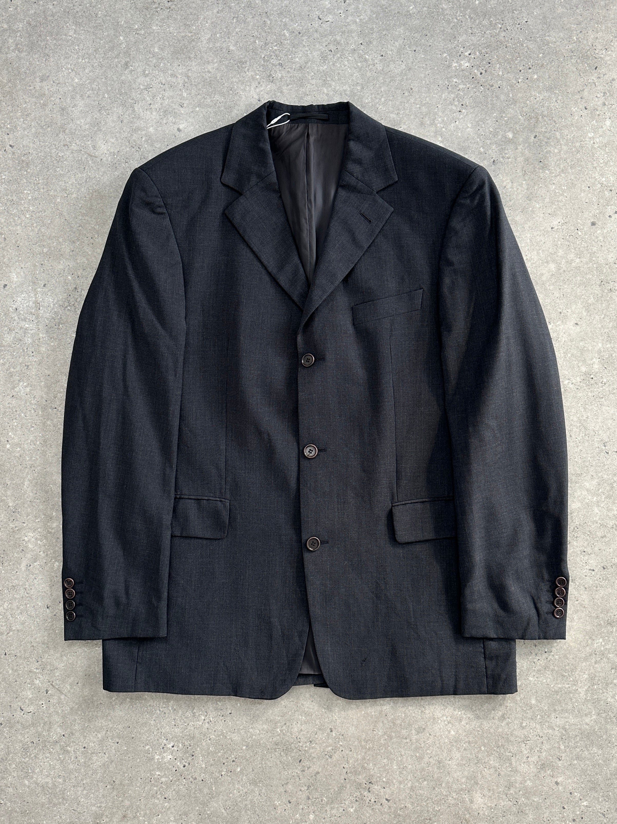 Hugo Boss virgin wool single-breasted blazer in size 42R/XL, tailored fit, dark navy color, shown on a hanger.