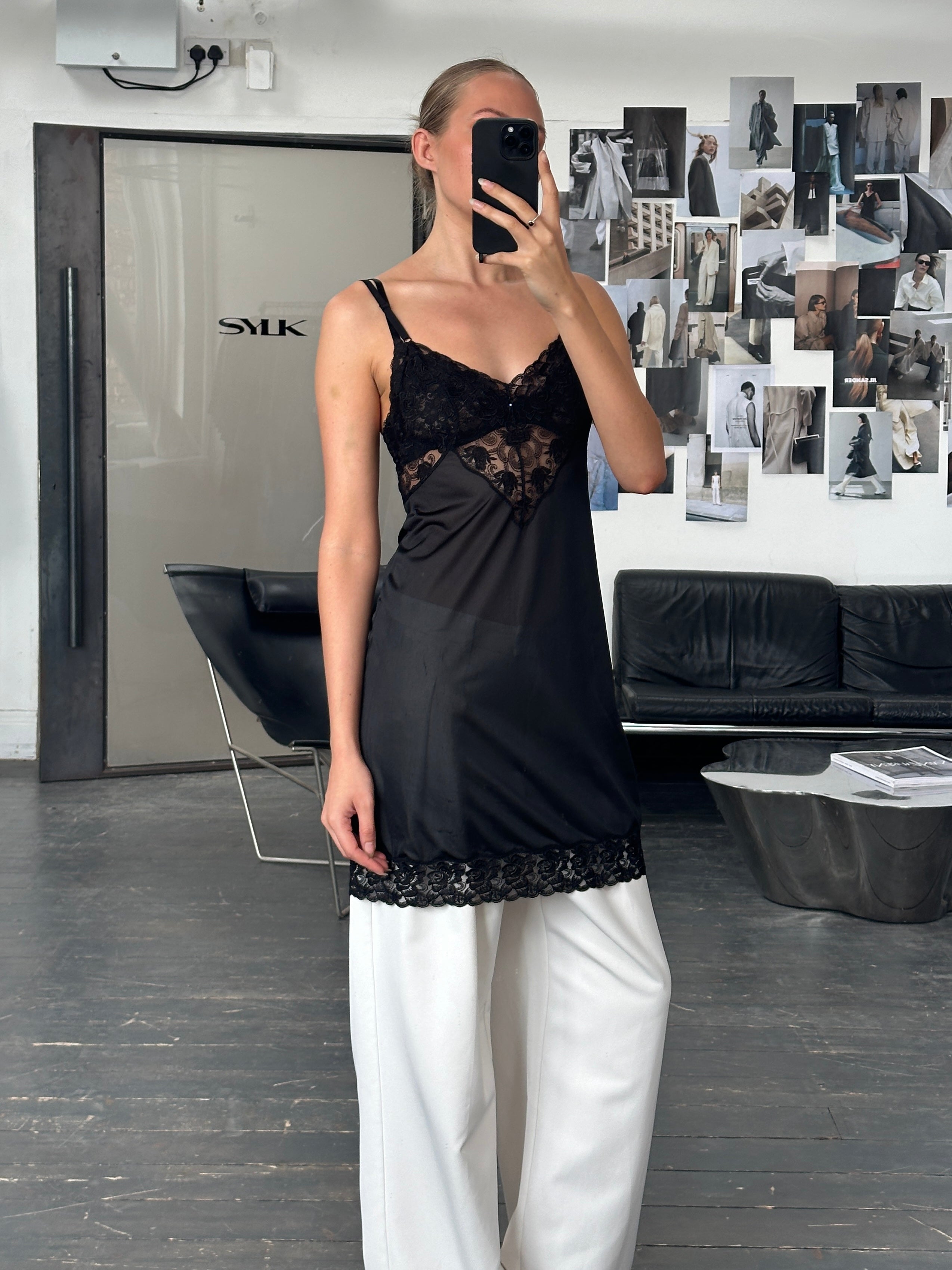 Vintage 1990s lace mini slip dress in black, featuring delicate lace details and a classic silhouette, size S/M.