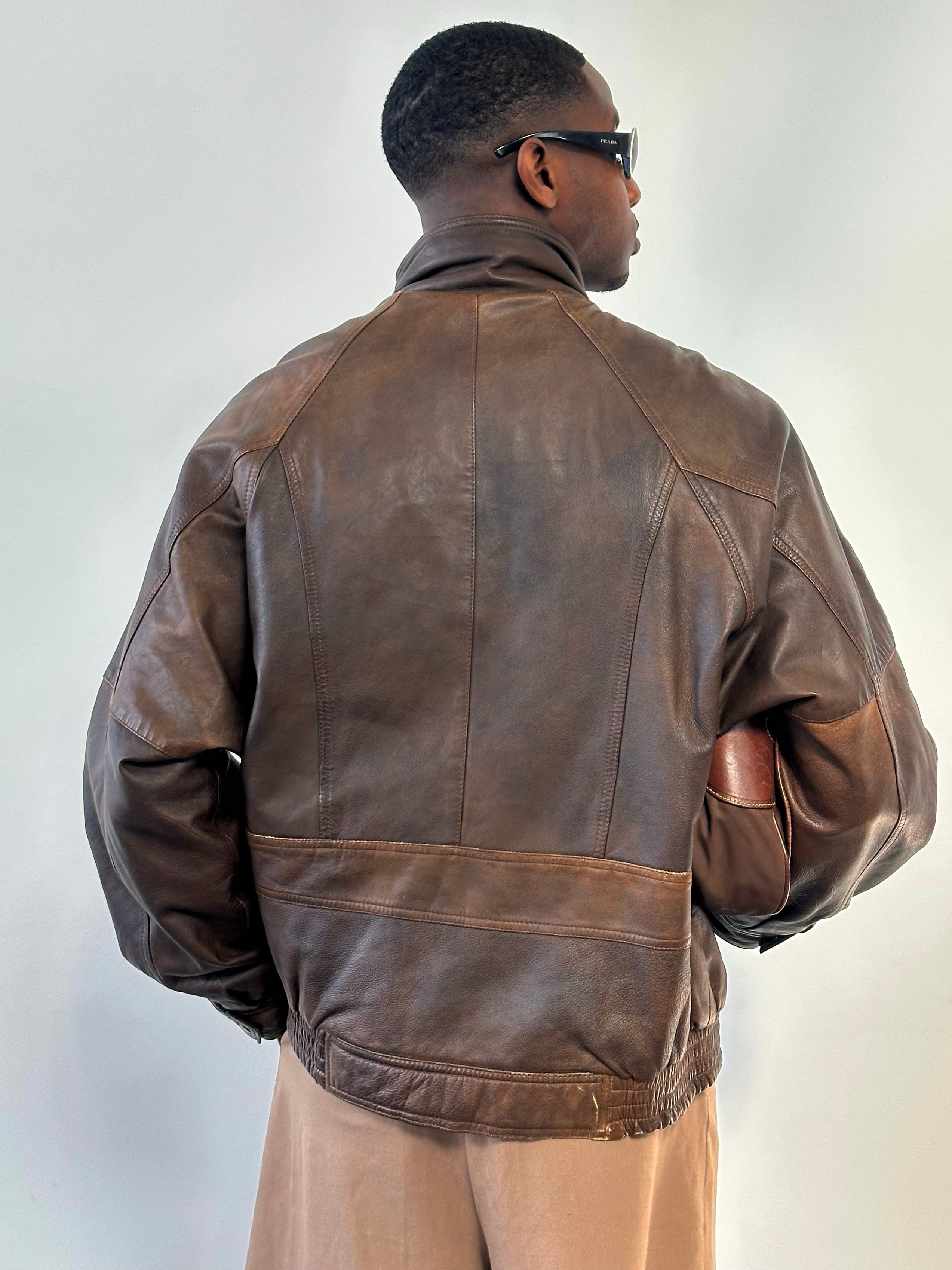 Vintage 1990s leather high neck bomber jacket in XL, showing the classic collar, shoulder details, and front zipper closure.