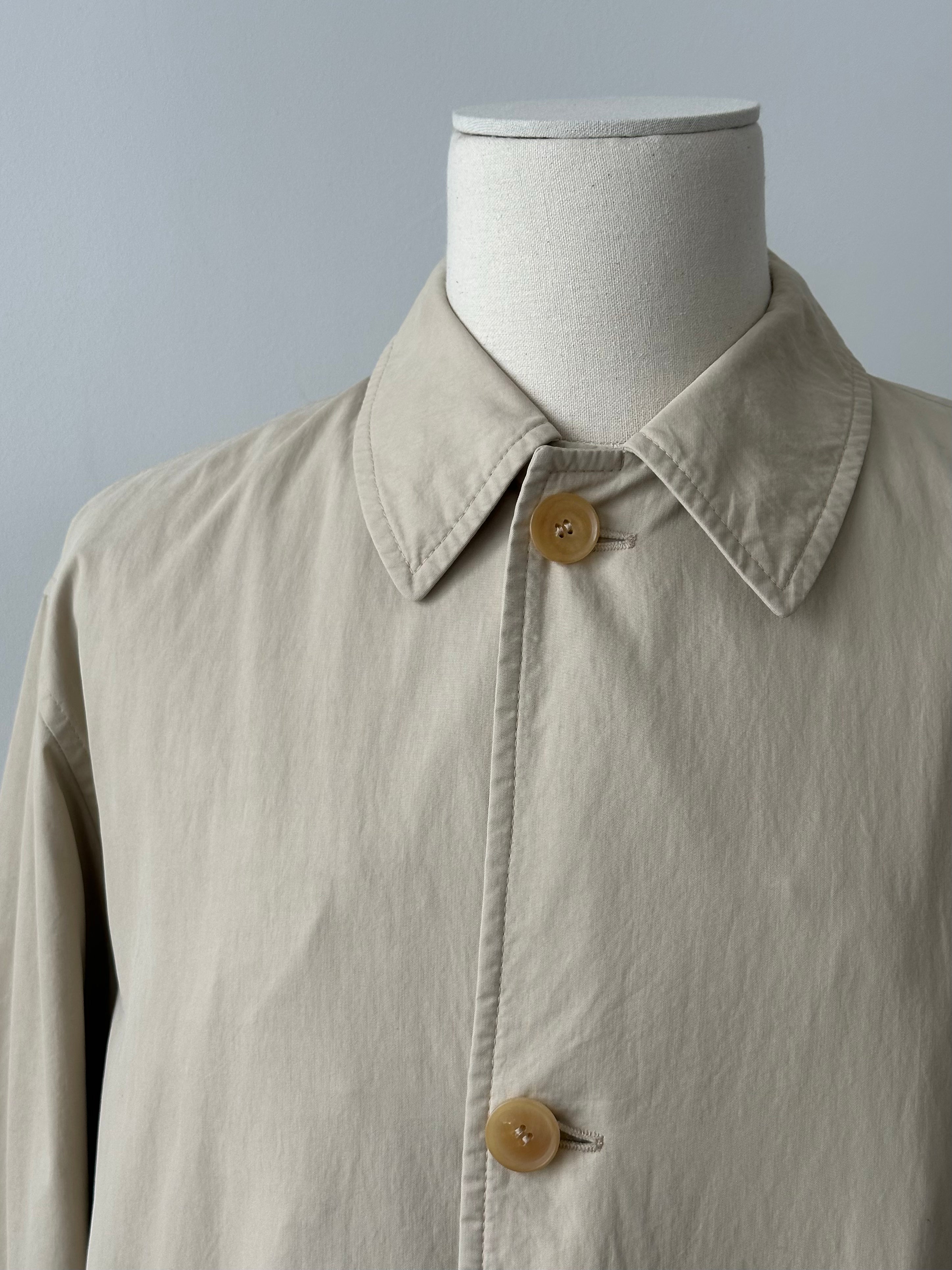 Hugo Boss 2000s cotton trench coat with concealed placket, classic design, beige color, and tailored fit.
