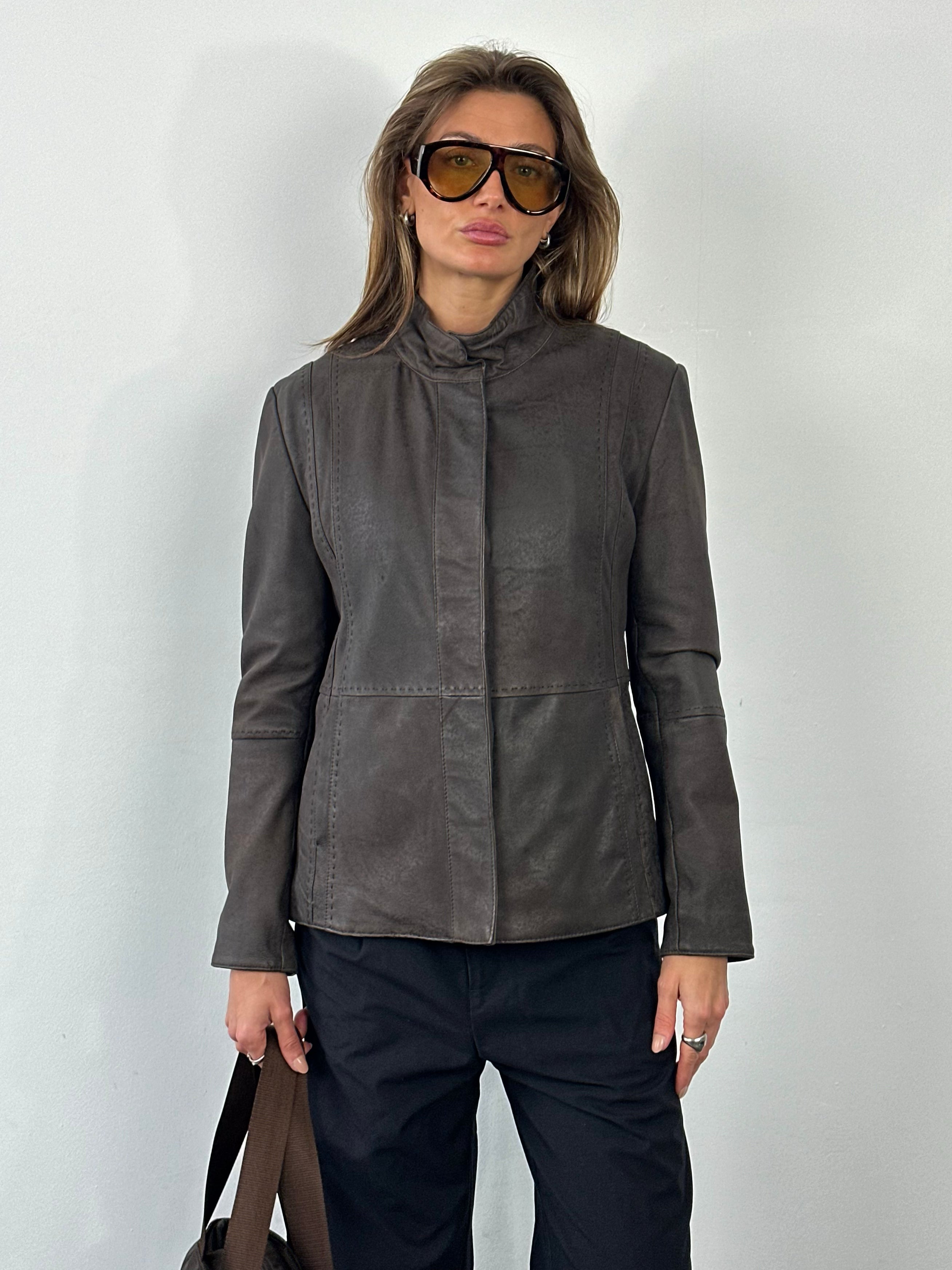 Vintage 1990s leather high neck jacket, size small, featuring classic leather material and retro design details.