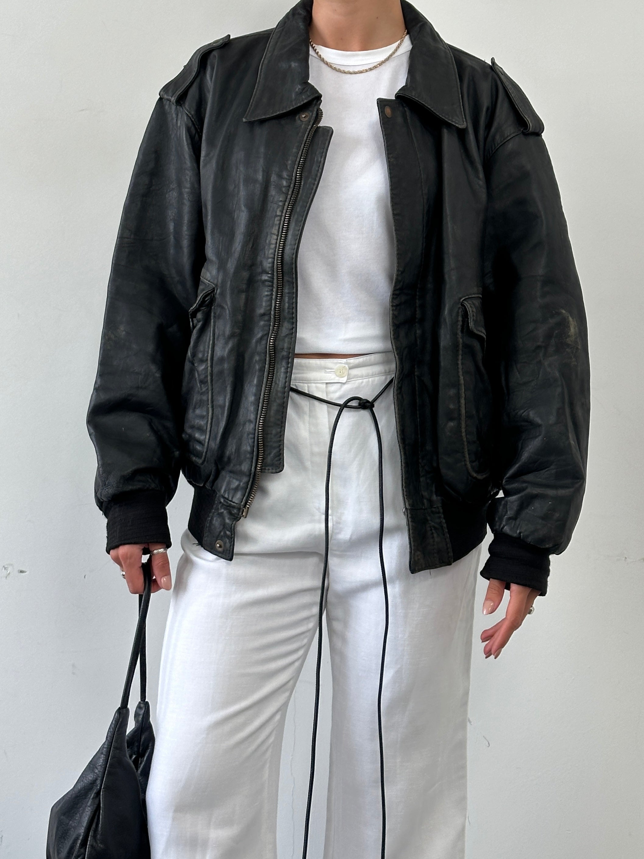 Vintage distressed leather bomber jacket in XL size, featuring a rugged style with worn-in details and classic design.