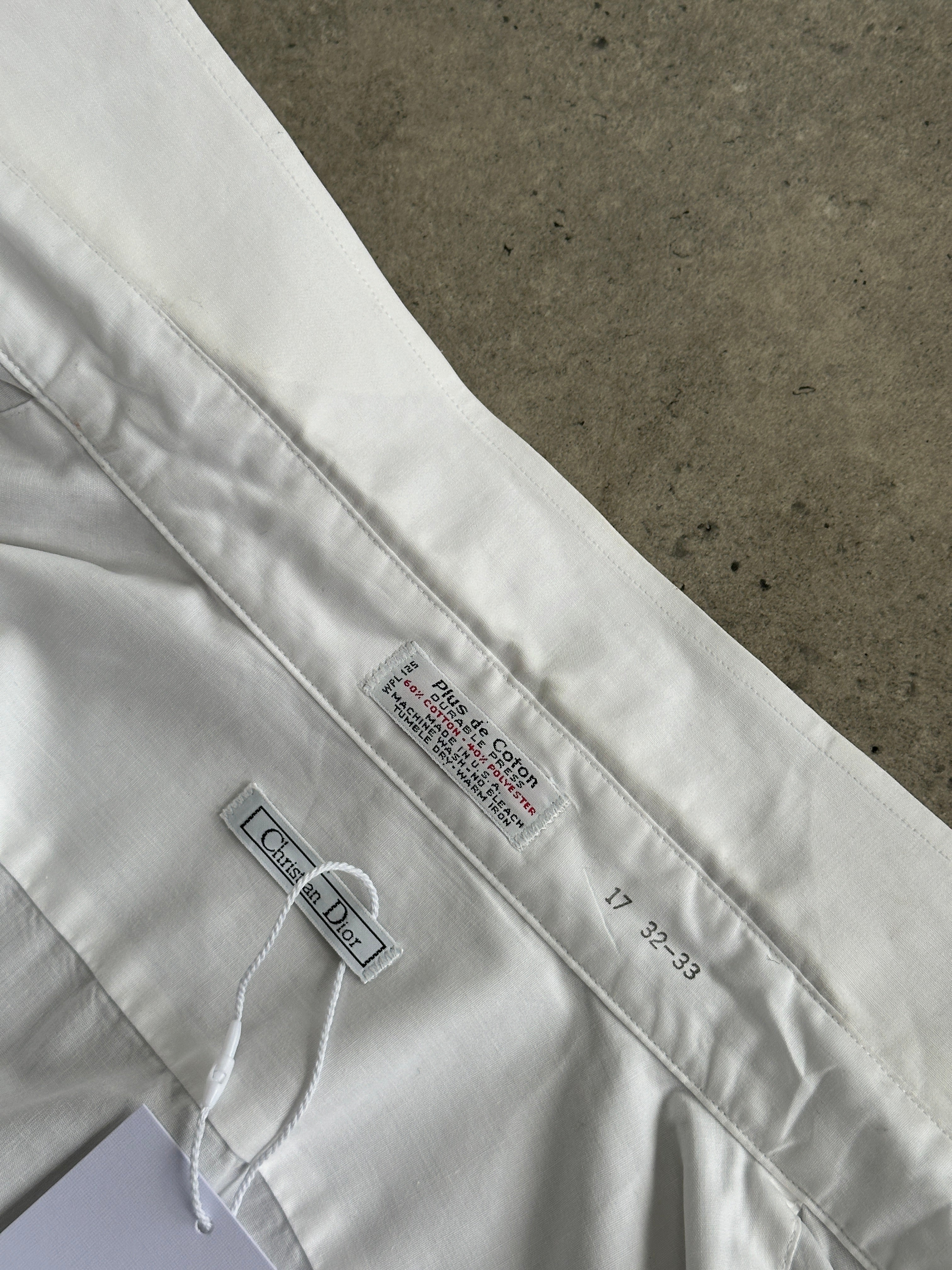 Christian Dior 1980s cotton shirt in size M/L displayed on a hanger, featuring classic design and high-quality fabric.