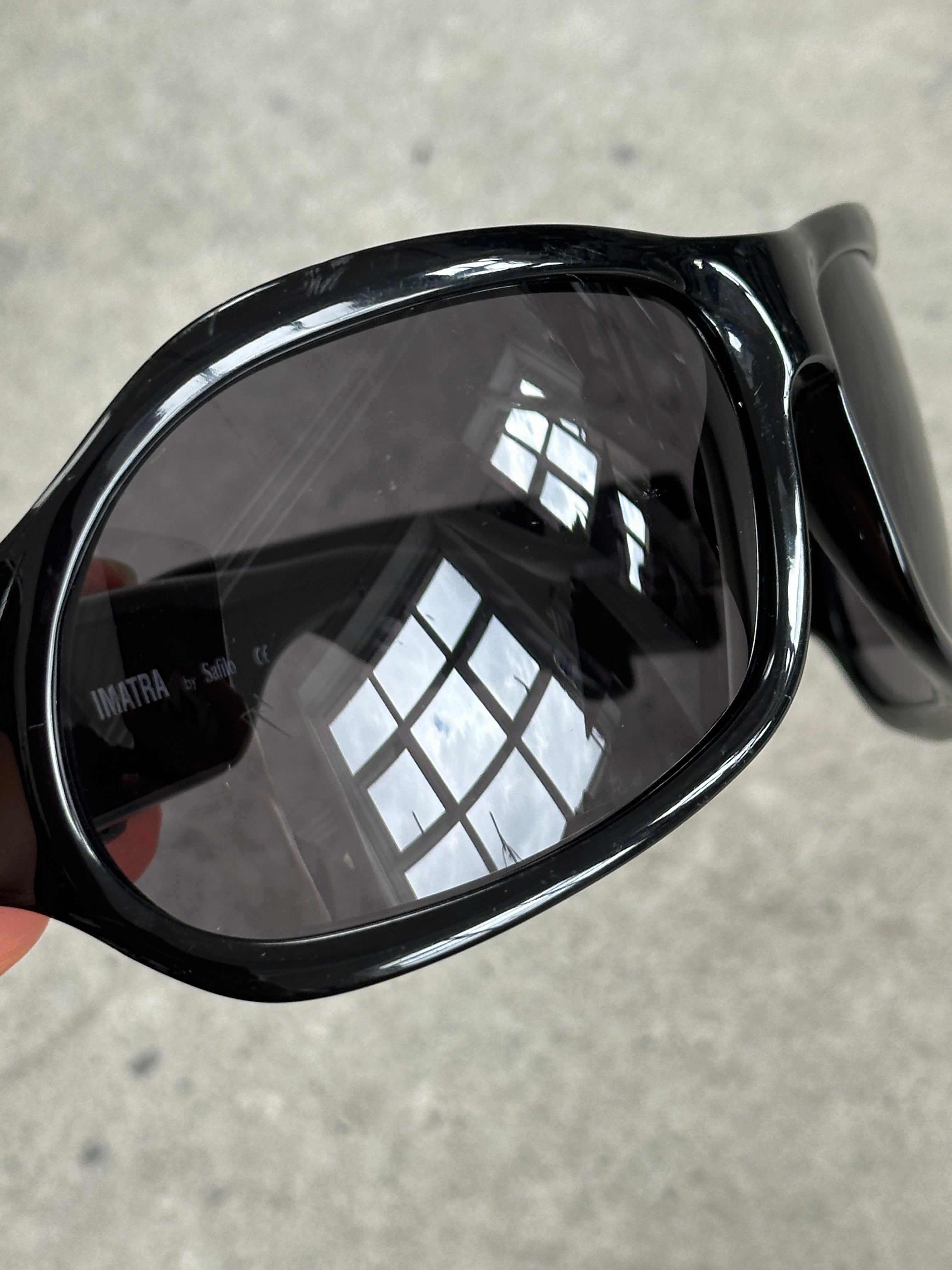 Vintage 2000s oversized shield sunglasses with bold design and dark lenses, featuring a vintage brand style and statement look.