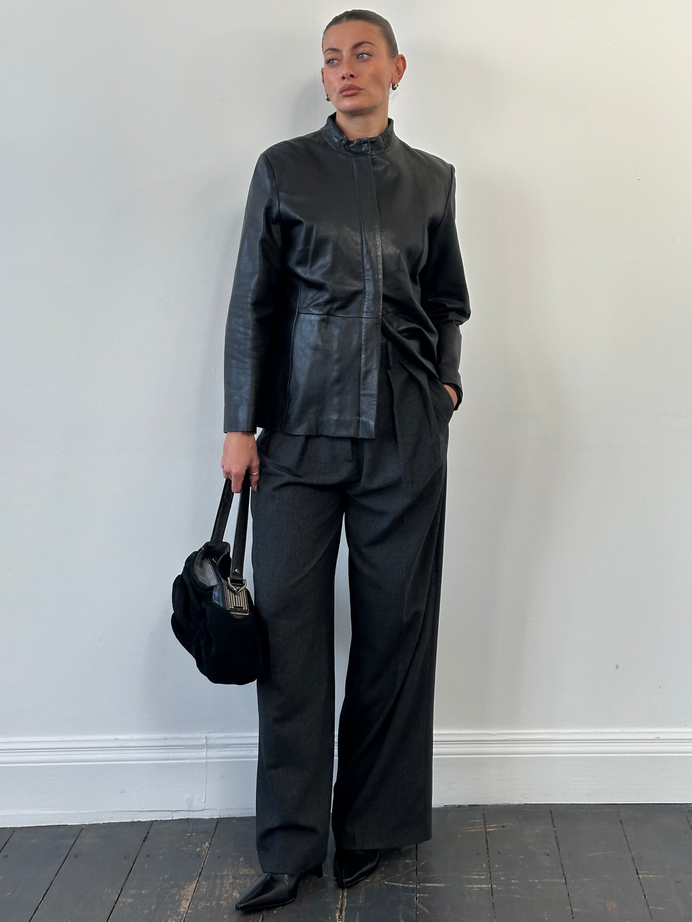 Vintage 1990s minimal round neck leather jacket in size M, classic black leather with clean, simple design.