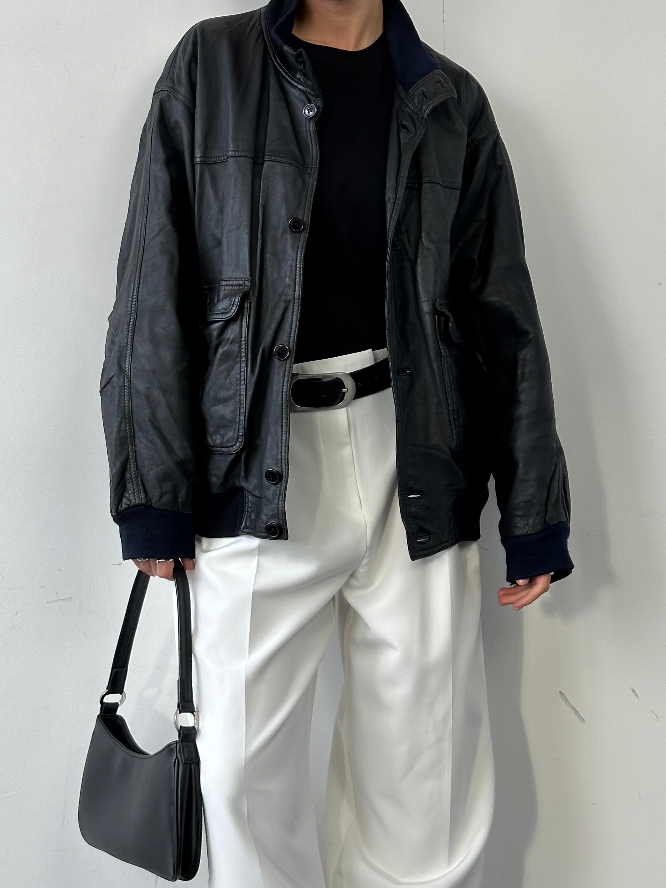 Vintage leather bomber jacket in size large/extra large, featuring classic design and detailed stitching.