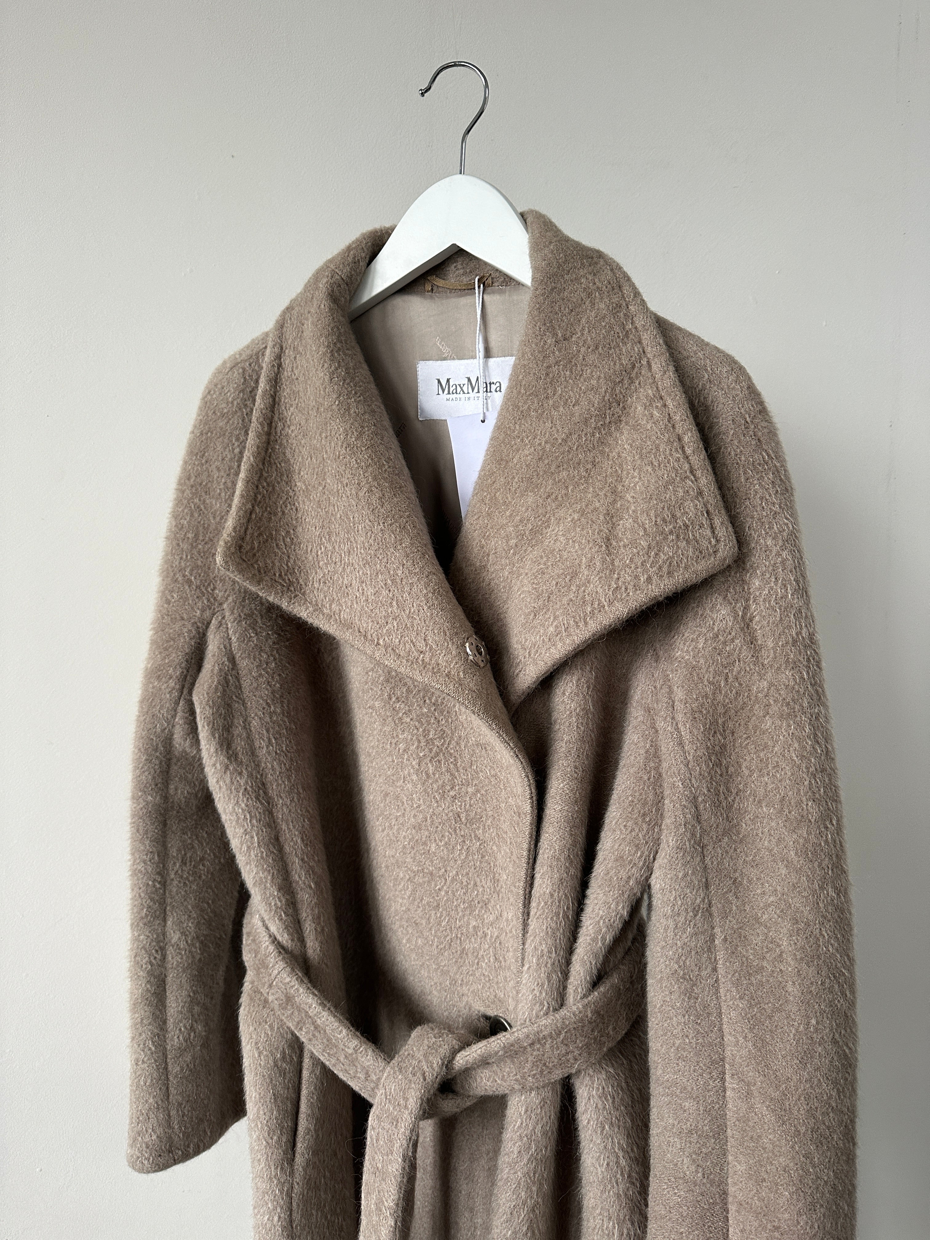 Max Mara alpaca wool belted wrap coat in neutral color, displayed on a hanger with front view.