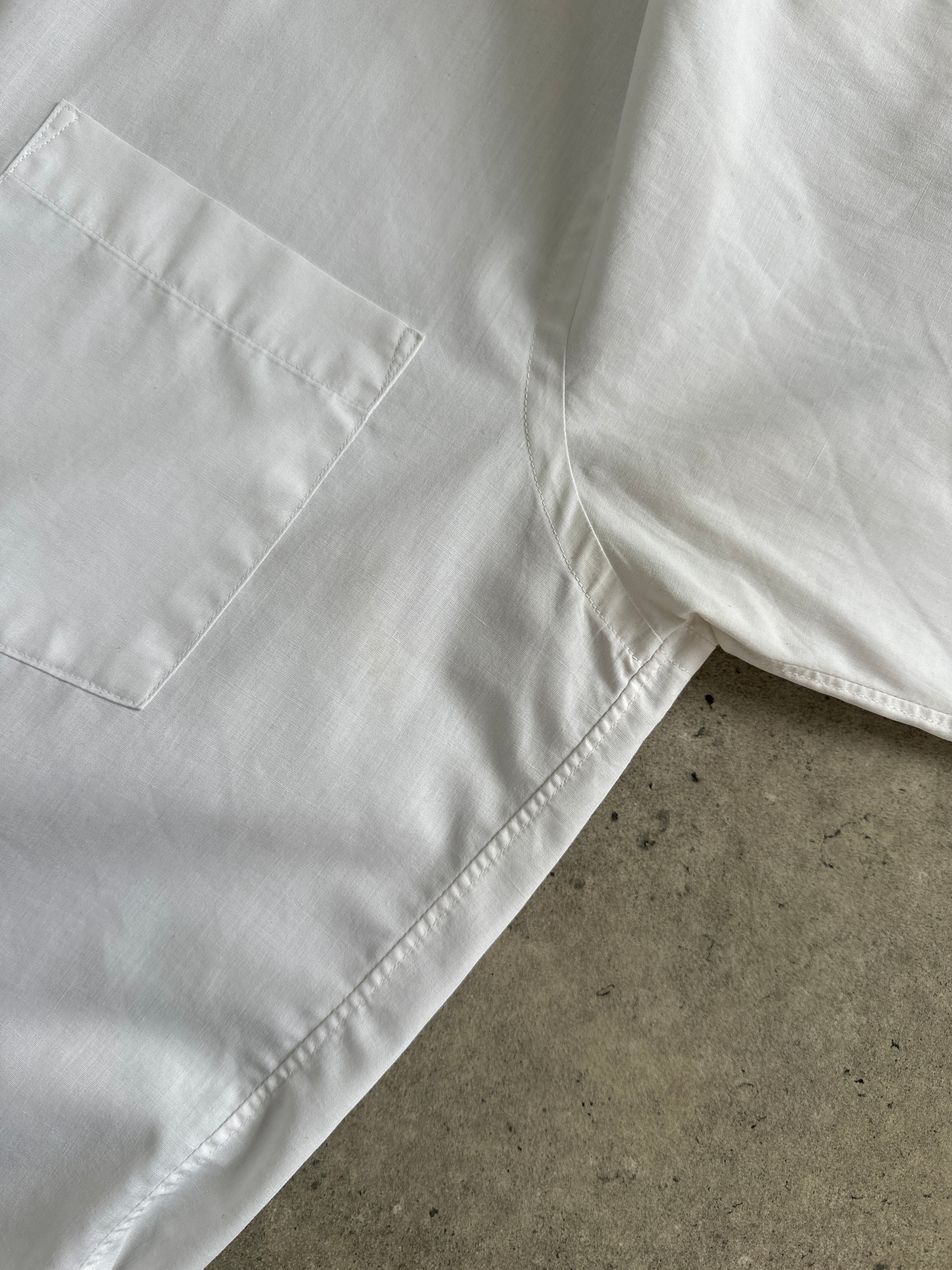 Christian Dior cotton dress shirt in size L, featuring a classic collar and button-down front, displayed on a hanger.