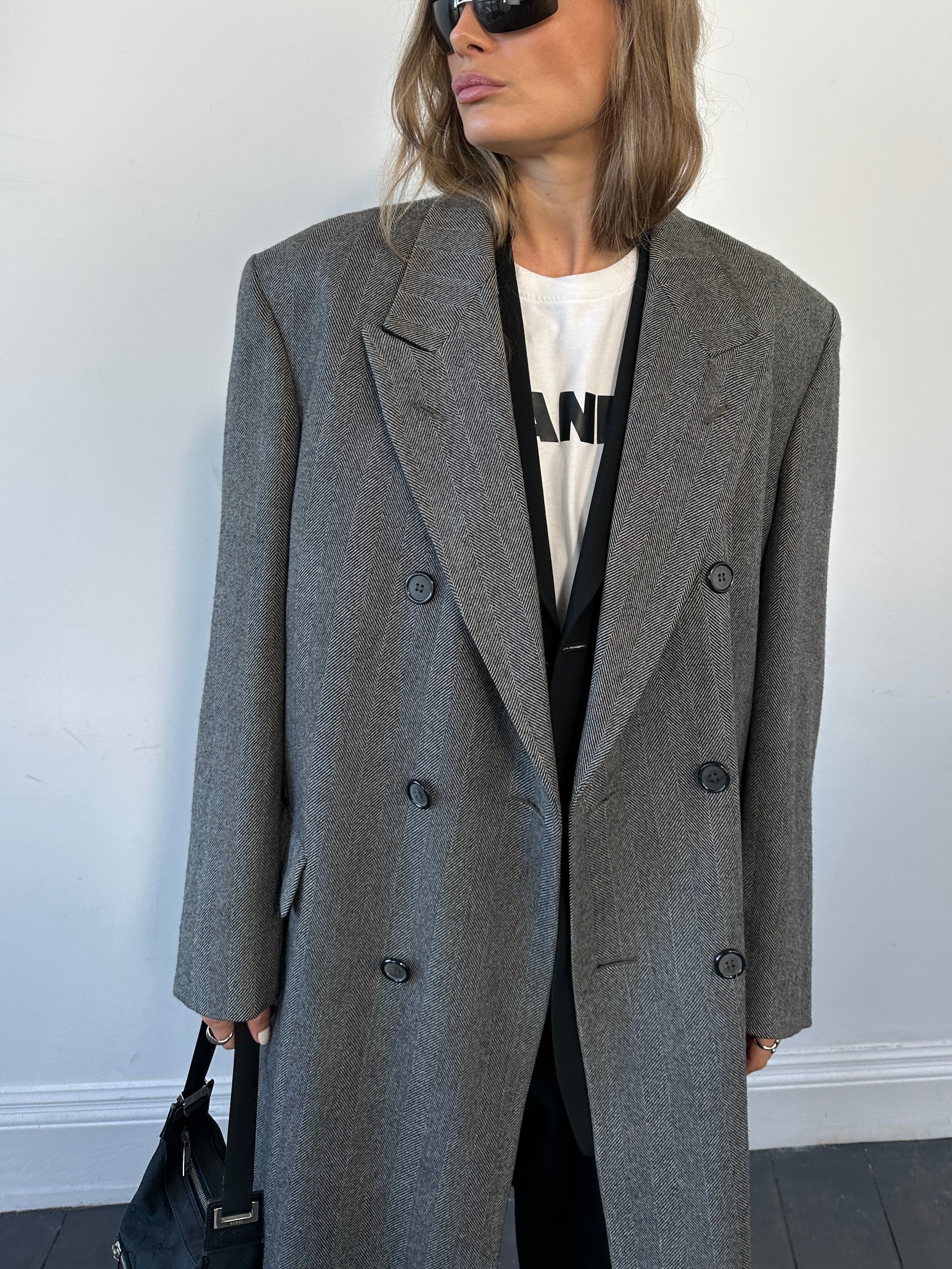 Vintage British pure wool double-breasted herringbone coat in size L/XL, featuring classic tailored design and warm winter style.