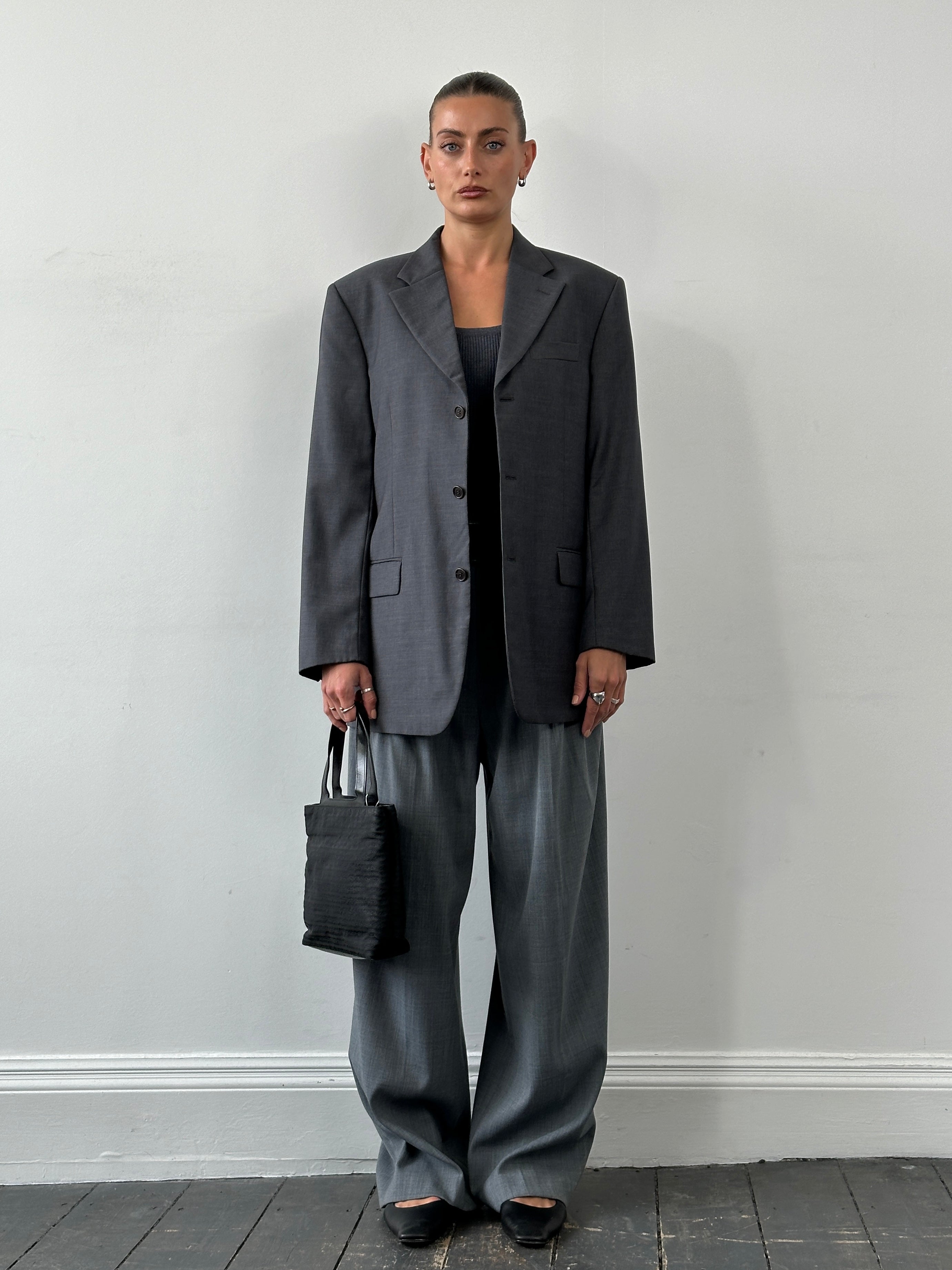 Gianfranco Ferre virgin wool single-breasted blazer in size 40R/L, shown in classic dark color with tailored fit and lapel collar.
