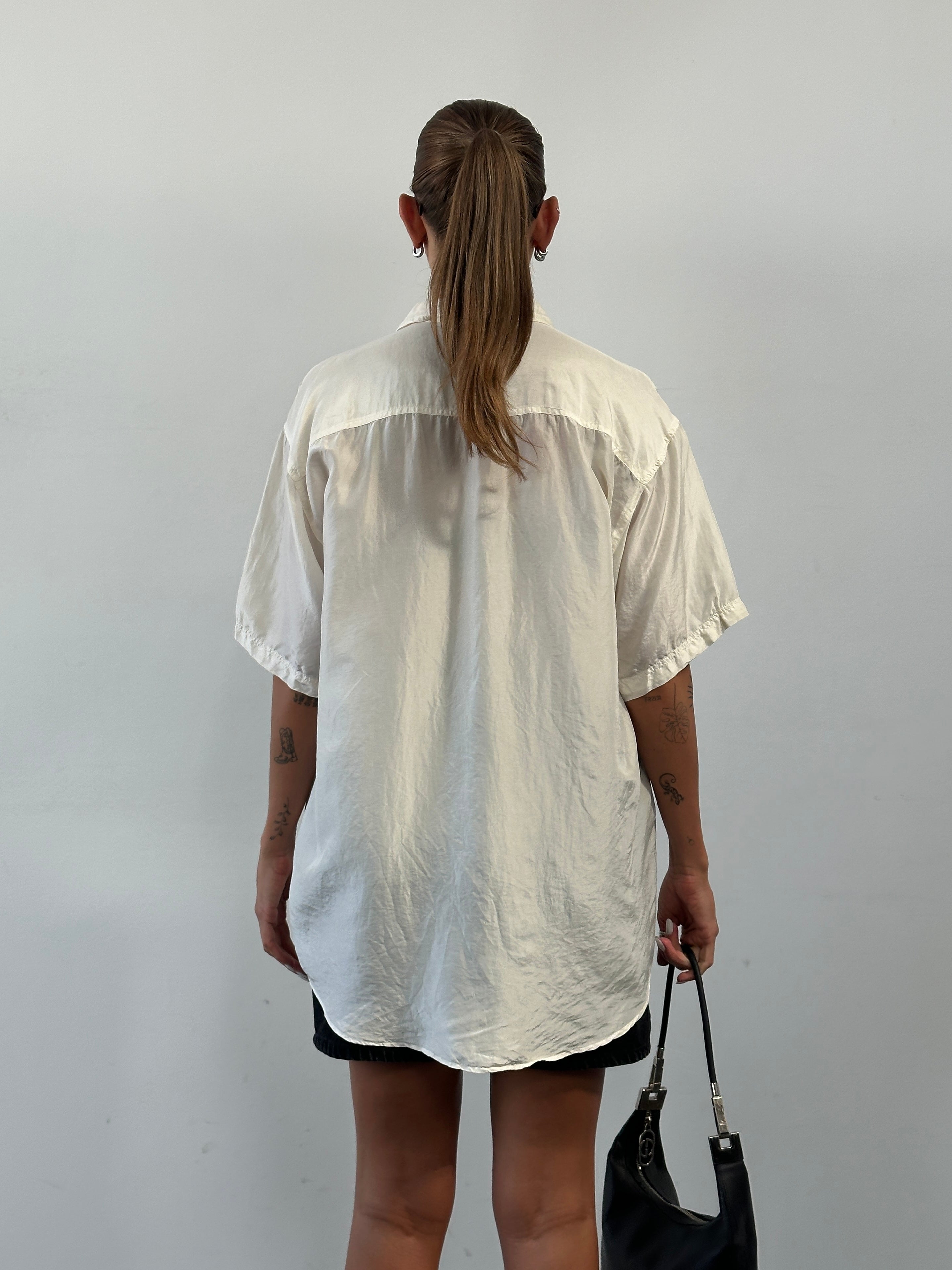 Vintage pure silk short sleeve shirt in XL, featuring a smooth texture and classic design, displayed on a hanger.