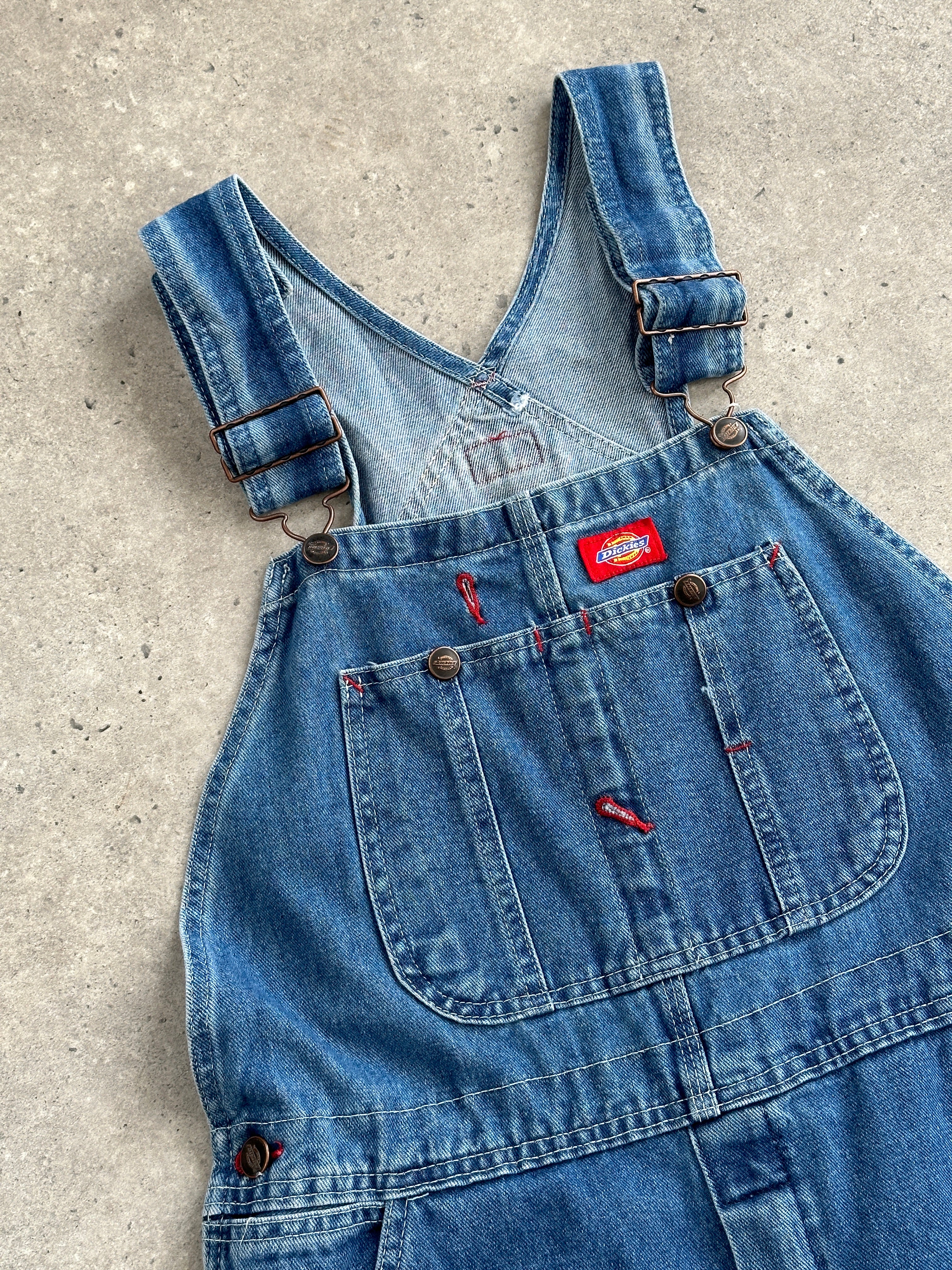 Dickies pure cotton denim dungarees in medium size, featuring classic blue denim fabric and adjustable shoulder straps.