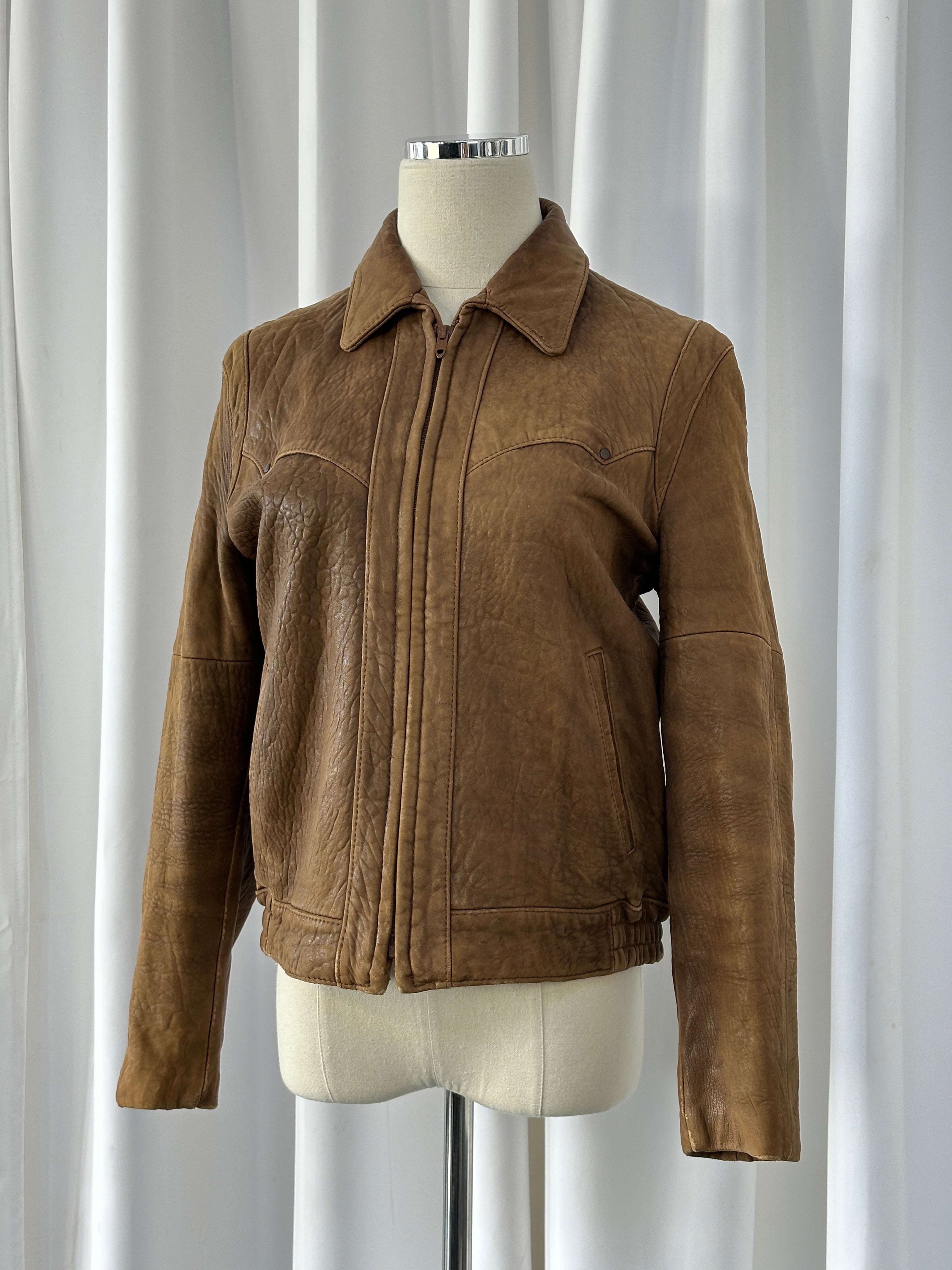 Vintage USA 1980s leather bomber jacket in XS/S size, featuring classic design and aged leather detail.