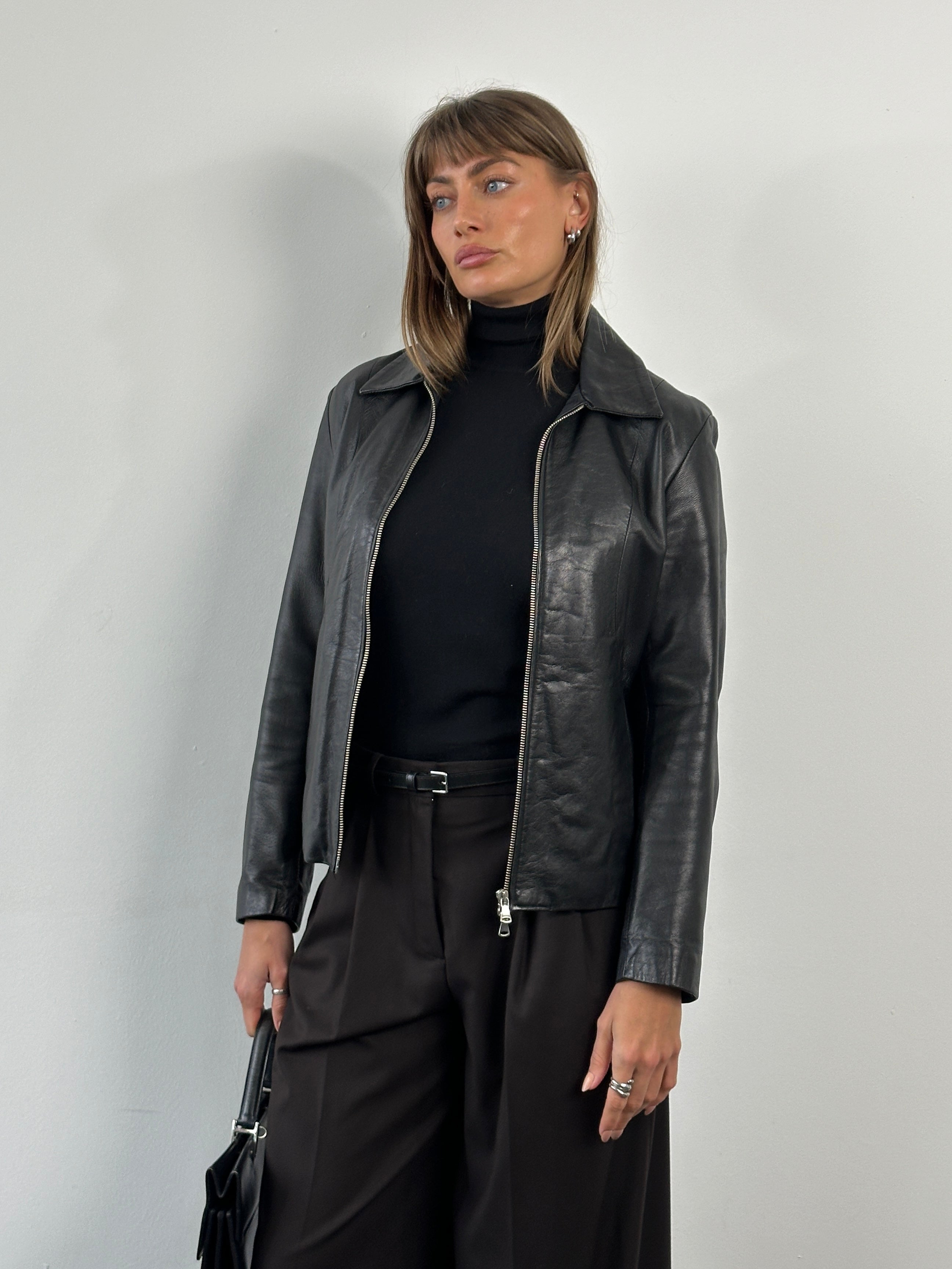 Vintage Italian 1990s double zip leather jacket in size small, featuring classic design and rich leather texture.