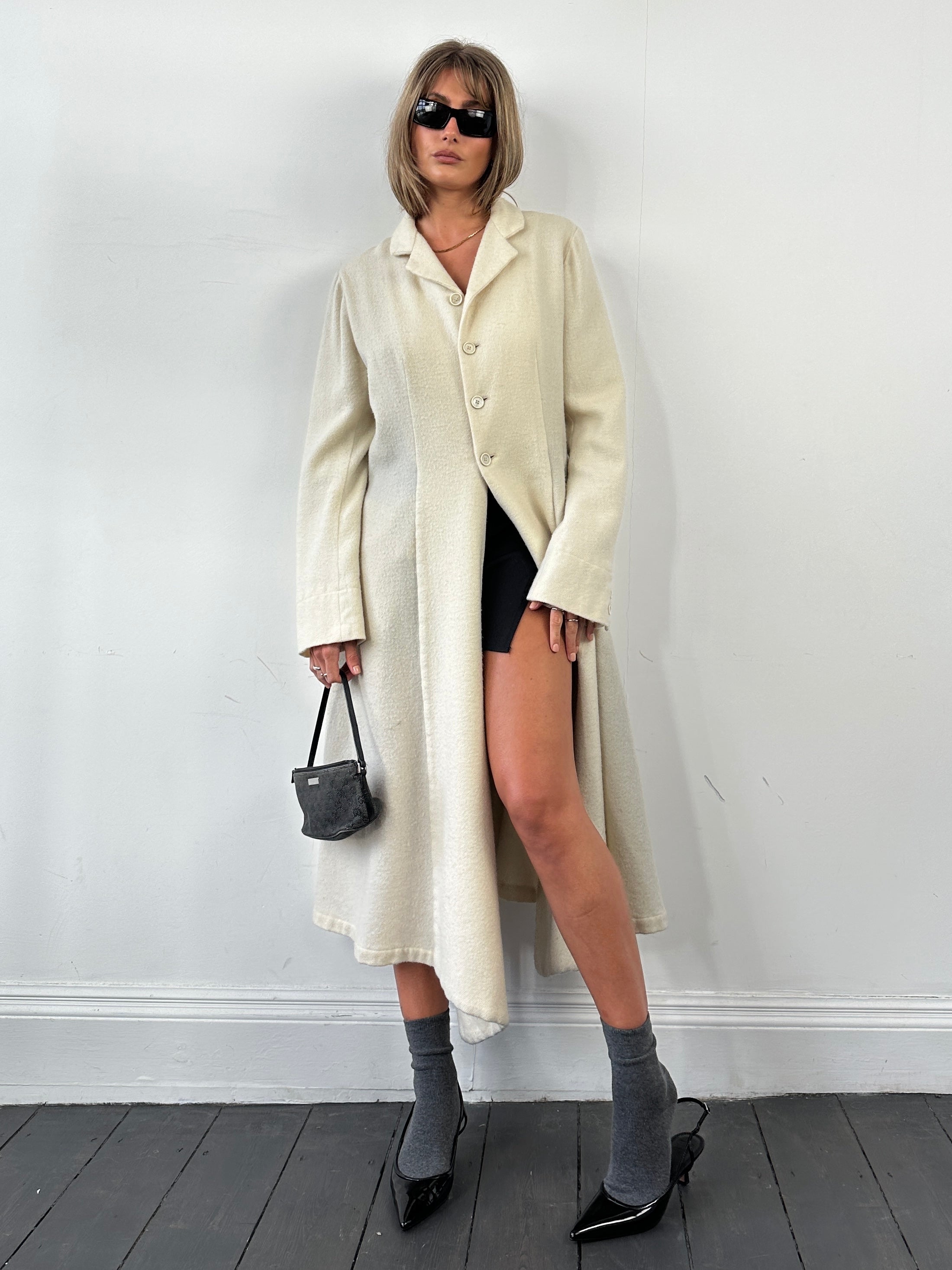 Comme des Garçons 90s unlined pure wool waterfall coat, front view showing draped design and neutral color, size M.
