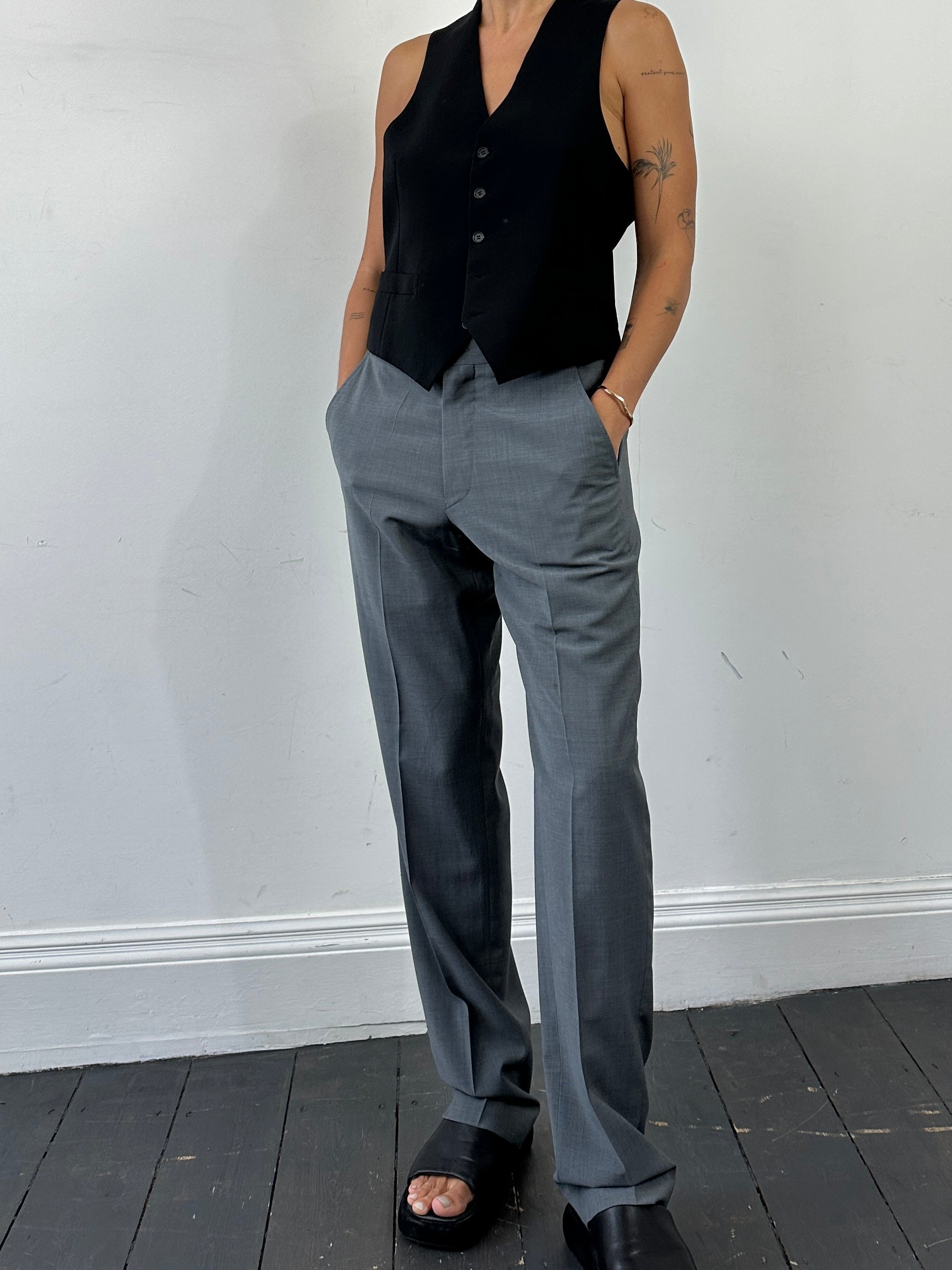 Emporio Armani pure wool high-waisted tailored trousers in dark fabric, front view showing sleek design and waistband.