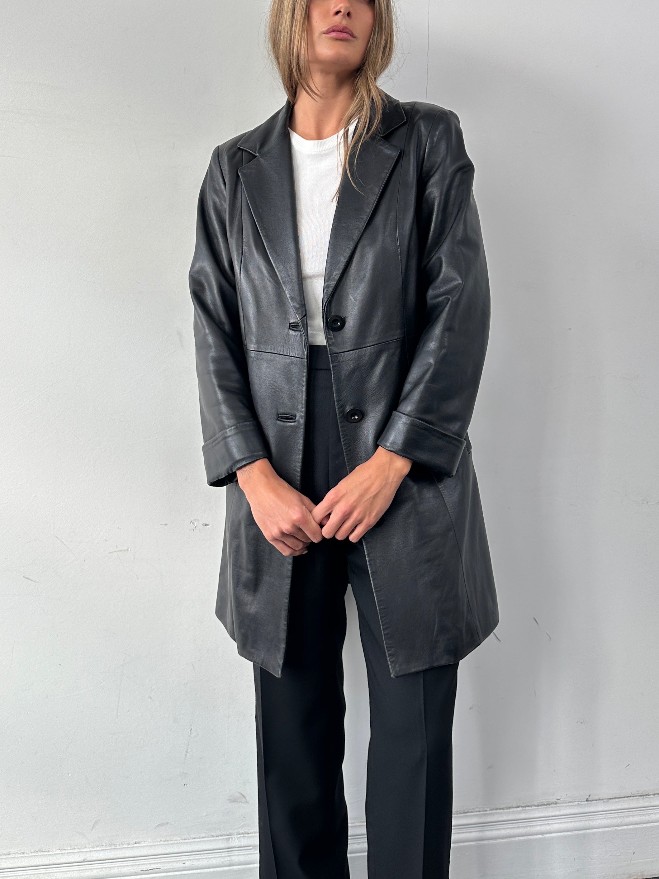 Vintage Italian leather mid-length jacket in classic style, featuring a sleek design and authentic vintage craftsmanship.