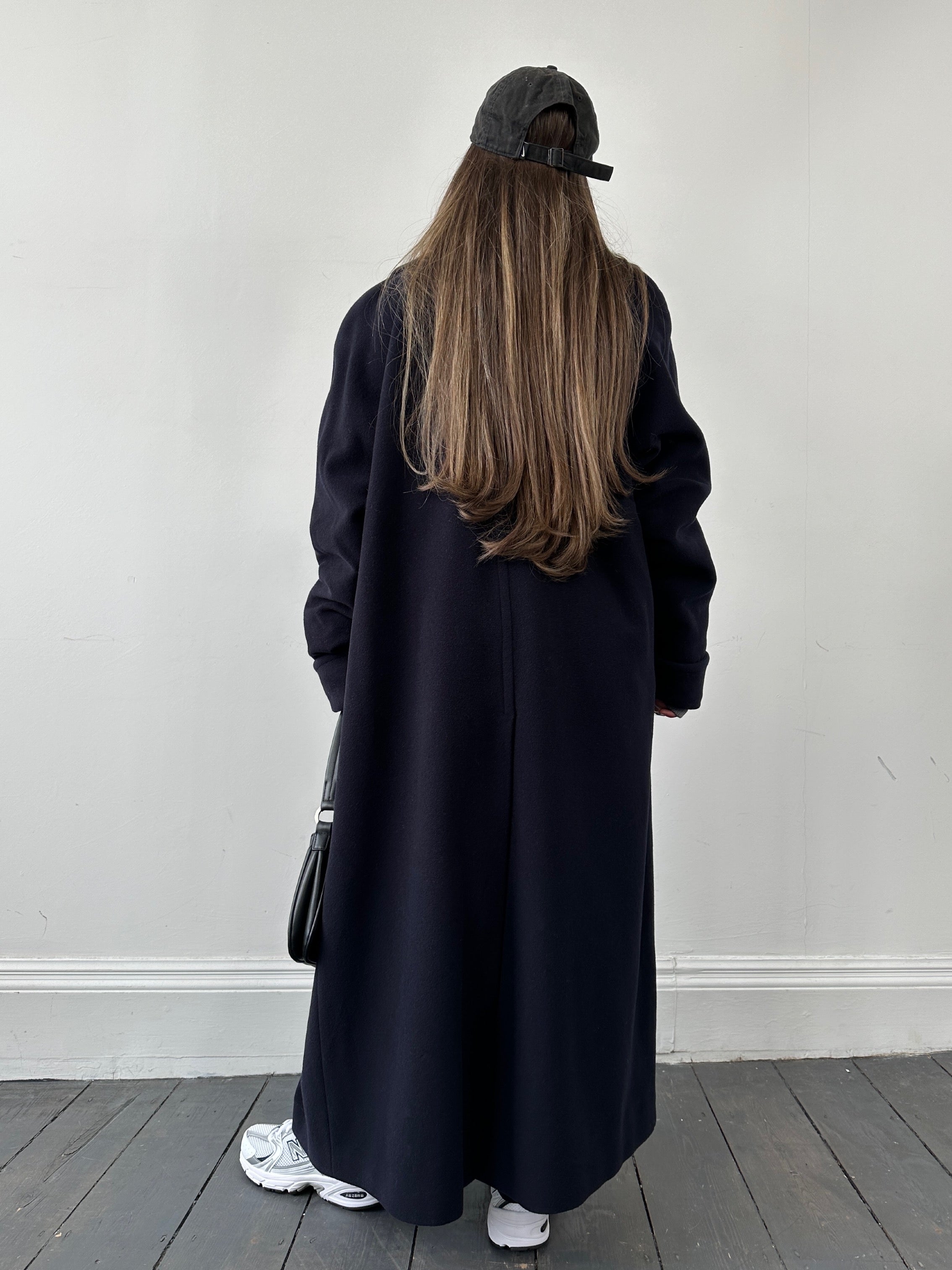 Vintage wool double-breasted coat in size M, featuring classic style and tailored fit, displayed on a hanger.