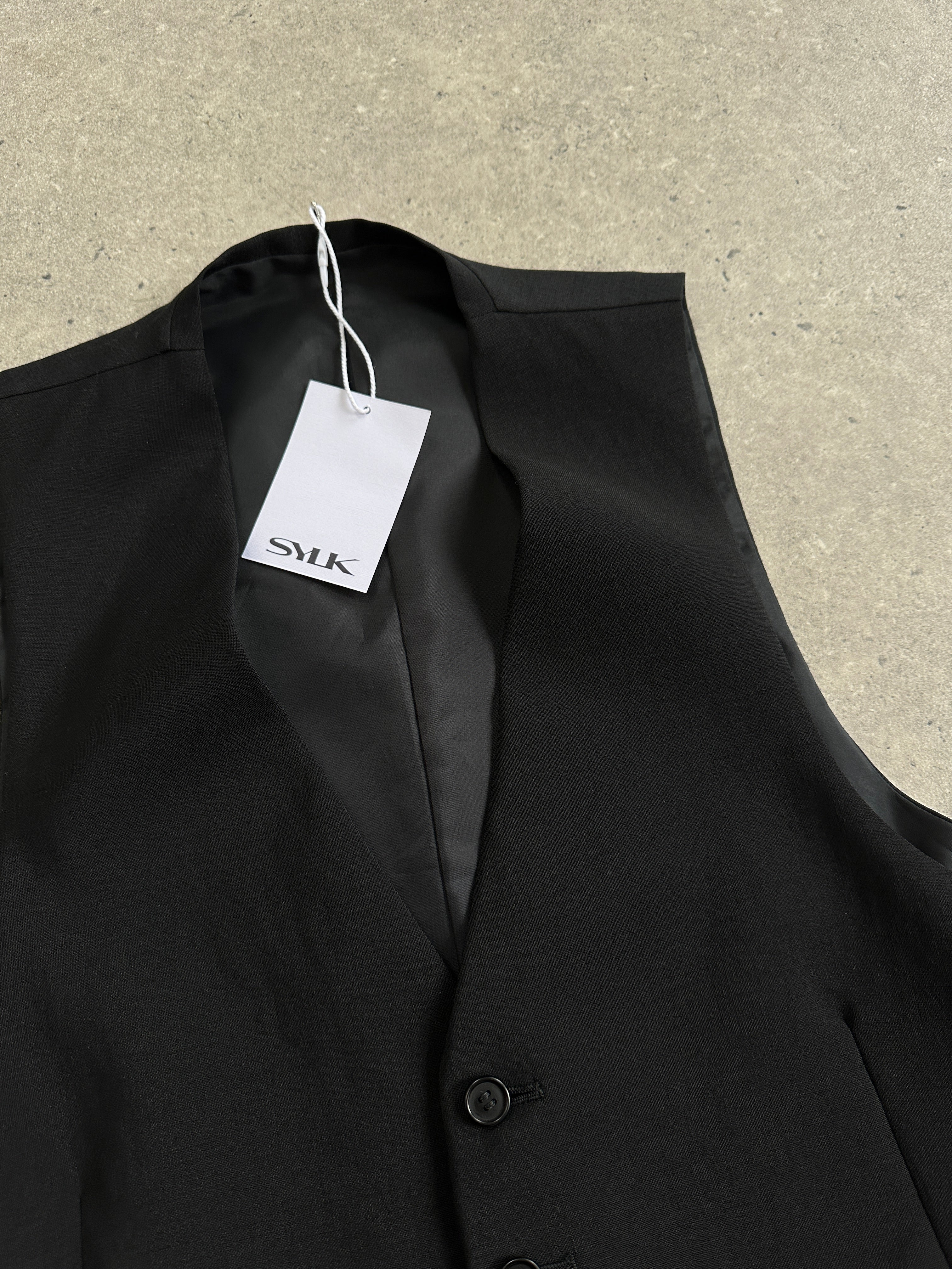 Vintage pure wool tailored waistcoat in size L, featuring classic design and button closure, suitable for formal or vintage-inspired outfits.